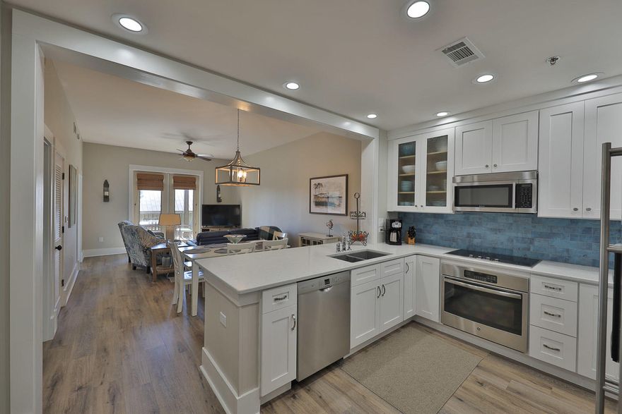 ***NEW QUARTZ COUNTER TOPS & BACKSPLASH /LUXURY VINYL FLOORING/ LED FLUSH MOUNT LIGHTING/OVEN/HVAC & FURNISHINGS*** Spacious and tastefully decorated ,2Bed/2Bath condo, is a great opportunity for an investment home. Unit M1-310 conveys fully furnished,and rental ready. Residence boasts many upscale features throughout; such as beautiful Luxury Vinyl floors, quartz counter tops, stainless steel Jenn Air/Viking appliances, spacious dual access balcony, and assigned covered parking space.This growing village community was specifically designed to connect residents with nature, and features a scenic trail along the wooden boardwalk down to the lake. Redfish has it's own private beach access. This unit is in excellent condition, due to the owners usage as a true second home for many years.