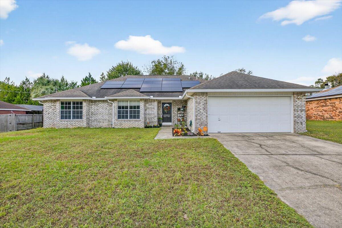 Assumable VA Loan @ 2.675% Located south of I-10 in Westview Estates, this all-brick single-story home offers a welcoming layout with three bedrooms, two full baths, and an additional office or flex room. The living room is bright and open, featuring cathedral ceilings and a fireplace that creates a warm focal point. The kitchen and dining area are designed for everyday functionality while still providing plenty of room for gatherings.The primary suite is spacious and thoughtfully arranged with double vanities, a garden tub, a separate shower, and a walk-in closet. Outside, the fenced backyard includes an open patio and storage building, making it easy to enjoy both leisure and practicality. With its convenient location near schools, shopping, and Eglin AFB, this home blends comfort and accessibility. Schedule your showing today!