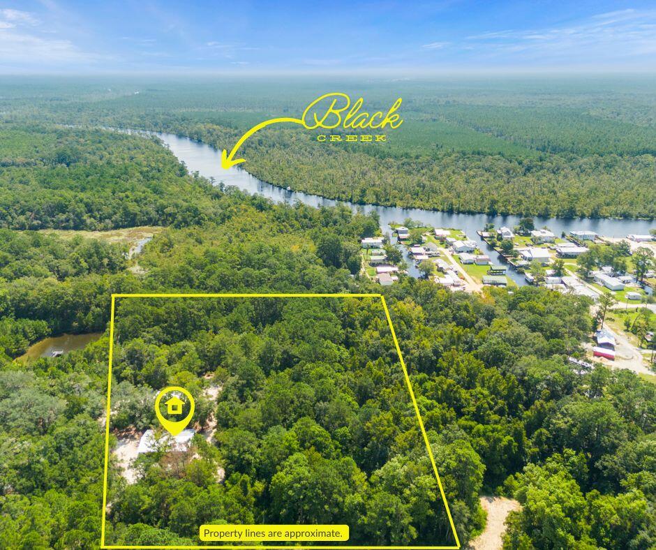 Here's your chance to own 6 gorgeous acres near Black Creek in Freeport with no HOA! The property includes: a 2018 mobile home covered by a 40x60 pole barn, an additional 24x36 pole barn, and hook-ups for 2 camper/RVs. The property is currently being used as a multi-family fish camp/retreat but has so much potential! Located off of the beaten path, the property offers privacy and quiet while still being minutes from the creek, bay or beaches. Approximately 1 acre is currently cleared, giving you a great start for creating your dream outdoor space or adding more camper/RV spots! As it stands, potential income for the property is $3000/mo. This is truly a rare find! Secure your family retreat before it's too late!