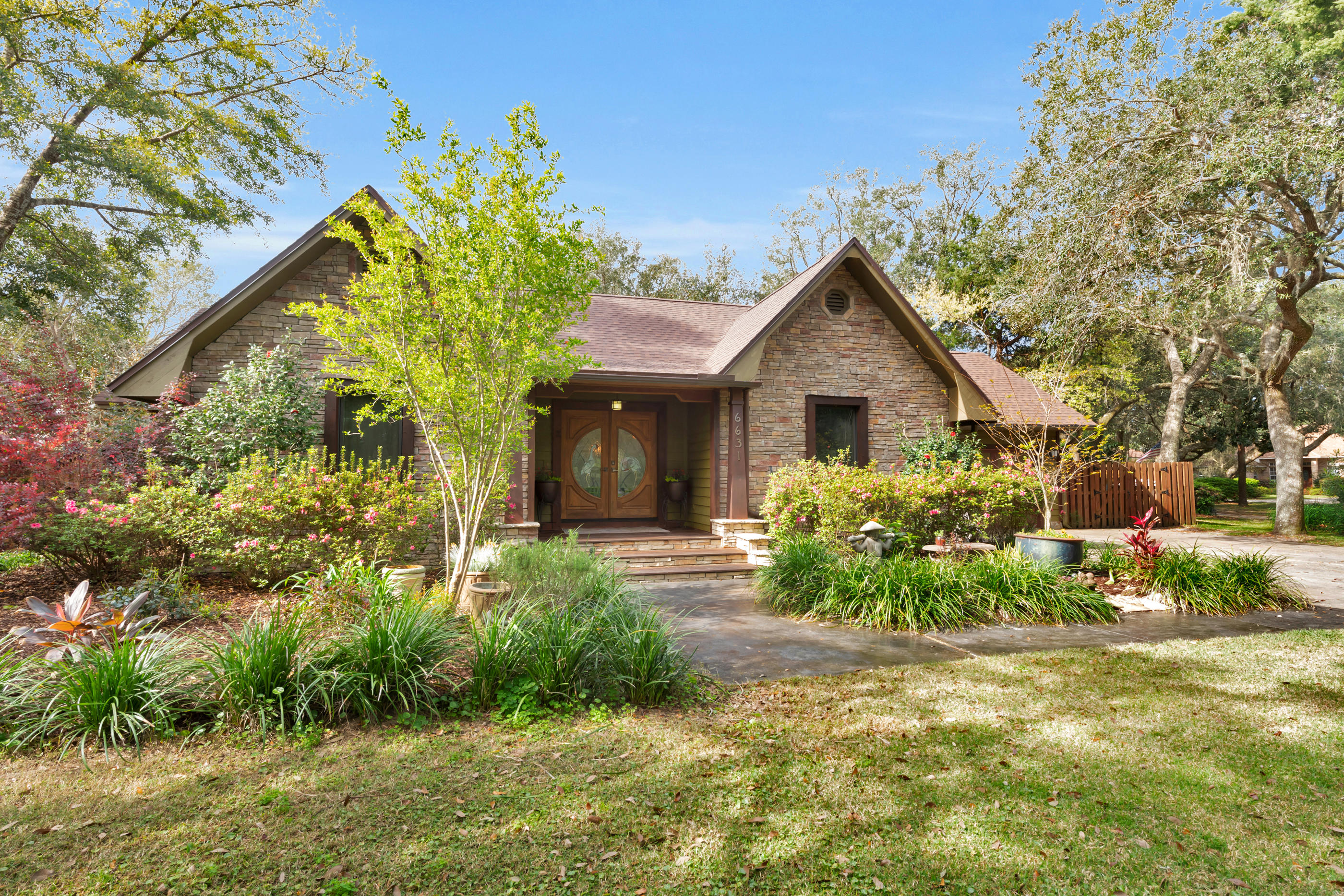 Waterfront .72 acreage in a desirable neighborhood! This home features a full landscape with a deep 103' waterfront lot. The home sale is equipped with a boat dock and lift for easy Bay access to fish, kayak, watch dolphins and paddle board. The home and boat dock recently got a new roof. If you seek a well taken care of property with an abundance of fruit trees, oaks and exotic plants, then you will love this retreat. It's located in a cu-de-sac and you will meet plenty of dog walkers, joggers and bike riders in this area. Real wood flooring, a soaker tub, split floor plan and private office space next to the half bathroom. There's a gorgeous stone fireplace and a wood beam across the cathedra ceilings that open up to the oversized kitchen island. Make your private tour appt!