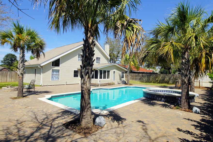 Spacious Four bedroom 2 1/2 bath home in the heart of the Destin Lifestyle. Minutes from the Gulf of Mexico; Boat Launch at Joe's Bayou, Fish or Kayak at Main Street Park or Swim in your Private Pool surrounded by a Paver deck and Palm trees with uplighting. Home features two living areas; the open dining/living space with dark hardwood-tile flooring and a Family room with gas fireplace. French doors in Family Room lead to Covered Screen Porch overlooking Sparkling Blue Swimming Pool with spa and large backyard. Kitchen boasts Corian counters, contemporary back splash,wood cabinets, and Stainless GE Profile Appliances. Palm trees in front of home add to curb appeal. Four bedrooms upstairs and Master bedroom with en suite bath, cathedral ceilings and French doors lead to covered balcony.