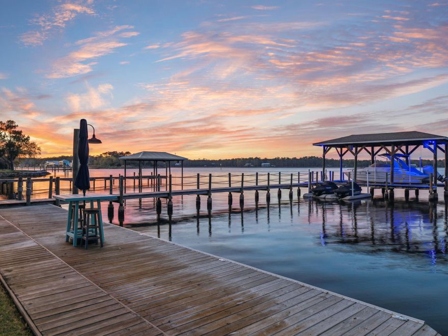 Live the ultimate waterfront lifestyle in this 2021-built Bayfront retreat, where newer construction meets deep-water access, a private dock and lift, and effortless access to the Gulf. Designed with the coastal boater in mind, this rare offering is perfectly positioned on 0.74 acres with 110 feet of Bay frontage, offering year-round 4-6 feet of deep water, no HOA, and just minutes to 30A. Whether you're cruising to Crab Island, paddleboarding at sunrise, or fishing the Intracoastal Waterway, every detail of this custom 4-bedroom, 5-bathroom home is tailored for luxury living on the water. The private dock has been fully upgraded with a 7,500-lb boat lift, Jet Ski floating dock, new electrical system, city water access, floodlights on timers, and snap jackets on the pilings for added durability. A private boat ramp makes launching kayaks and paddleboards a breeze.
The outdoor area is a true entertainer's haven, featuring a 30' x 15' saltwater pool with heating, cooling, and ultraviolet sanitation, plus a pool house with full bath, NatureKast cabinetry, and a large screened-in porch with wood ceiling and color-changing LED lighting.
Inside, enjoy Bay views from the main living spaces, a chef's kitchen with GE Caf?? appliances, pot filler, wine fridge, and under-cabinet lighting. The spacious dining area easily seats 8-10, while the primary suite offers stunning water views, dual walk-in closets, and a spa-inspired bath. Each bedroom includes its own en suite bath, with one guest room offering a soaking tub and another with water views.
Additional features include smart home integration (HVAC, garage doors, built-in speakers), three garages, a mudroom/laundry with built-in workspace, and abundant storage.
This is more than a home,it's a lifestyle. Paddle. Cruise. Fish. Entertain. Relax. All with no HOA restrictions and direct access to Florida's best waterways. 
