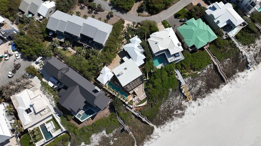 Welcome to 239 Pelican Circle--an exceptional Gulf-front home tucked behind the gates of one of 30A's most private and coveted streets. Just steps from Alys Beach and minutes from Seacrest and Rosemary, this property blends location, privacy, and direct beach access into a rare opportunity along the Emerald Coast.Set on a generous .34-acre lot, this five-bedroom, five-bathroom property includes a detached guest house with its own private suite--perfect for visiting guests, extended family, or a private workspace. The layout is ideal for both full-time living and rental income, offering multiple living areas, ample outdoor space, and a seamless connection between indoor comfort and Gulf-front views.Recent updates include brand-new impact-rated sliders and windows, a fresh full exterior repaint, and a completely redone outdoor deckall designed to enhance the home's durability and coastal appeal. Inside, natural light pours through expansive openings, highlighting the panoramic Gulf views from the main living area and primary suite.

Outdoors, enjoy a spacious deck perched above the dunes with direct, private beach access. Whether you're hosting a sunset dinner or enjoying a quiet morning coffee, the setting is unforgettable.

With a strong rental track record and walkability to Alys Beach, Rosemary, and Seacrest's best shops and restaurants, this home is as much a smart investment as it is a personal retreat. Properties like thisGulf-front, low-density, and south of 30Ararely become available. 239 Pelican Circle is your chance to own something truly special along 30A