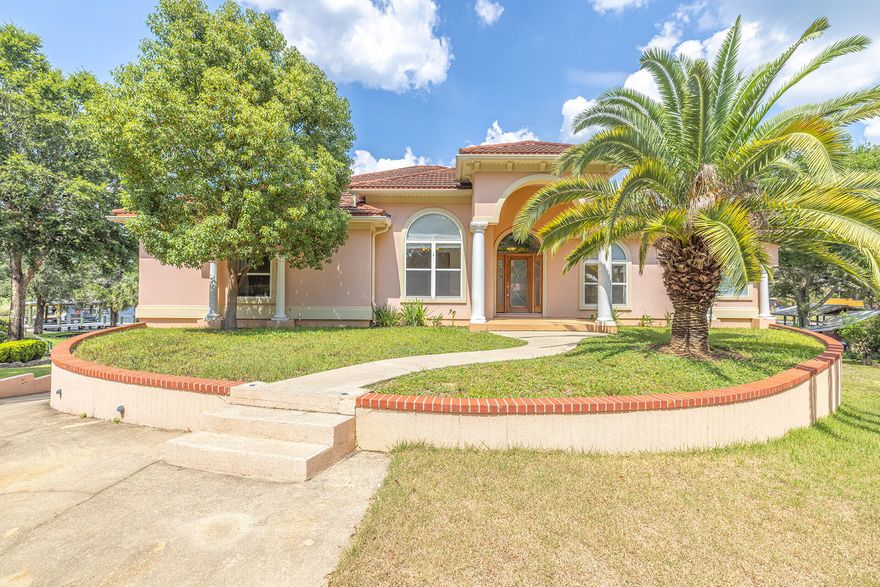 Enjoy WATERFRONT living at its finest! Custom built executive home with DEEP WATER access to Rocky Bayou. Located at the end of a cul-de-sac, this beautiful home features 5 bedrooms, 3.5 bathrooms, and an oversized 3-car garage. Open floor plan with a large screened in balcony where you'll delight in colorful sunrises, afternoon breezes and magnificent sunsets over the canal.Spacious living space with high ceilings, crown molding, and a fireplace surrounded by built-ins. The kitchen offers granite countertops, stainless steel appliances, and travertine flooring.Luxurious primary bedroom with walk-in closet, and private access to the screened balcony; the relaxing en-suite bathroom features a double vanity, soaking tub, and separate tiled shower