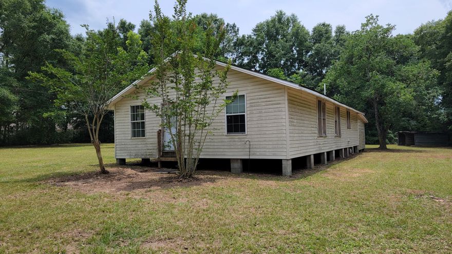 Great bones, fantastic yard, it's location has easy access to Hwy. 85 North and it sits amongst brand new construction homes!  Use your DIY skills and HGTV knowledge to make this one your own!  As you step in the front door, you have the 1st bedroom to your right and a smaller room, possibly 3rd bedroom or office space, on your left!  Then, you step straight into the large living and dining space.  You'll find the kitchen in the rear of the home with a door that leads out to the back porch. On the other side of the home, you'll find the renovated bathroom - done a few years ago, the laundry room, another living area and the 2nd bedroom.