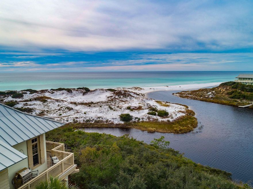 Set on one of the most coveted parcels along 30A, this iconic residence in the private community of The Retreat delivers a truly rare opportunity. Perched high above the dunes, it commands breathtaking vistas of Draper Lake's outfall and the shimmering Gulf of America. Offering an extraordinary blend of elevated privacy and generous lot size, this Tom Christ-designed concrete block masterpiece sits gracefully within a 90-acre enclave boasting 3,000 feet of private beach. Inside, reclaimed heart pine floors infuse warmth throughout the reverse floor plan, while pro-line appliances, a two-car garage, and timeless finishes elevate everyday living. This is not just a coastal residence, it's a rare chance to own one of The Retreat's most extraordinary homes!