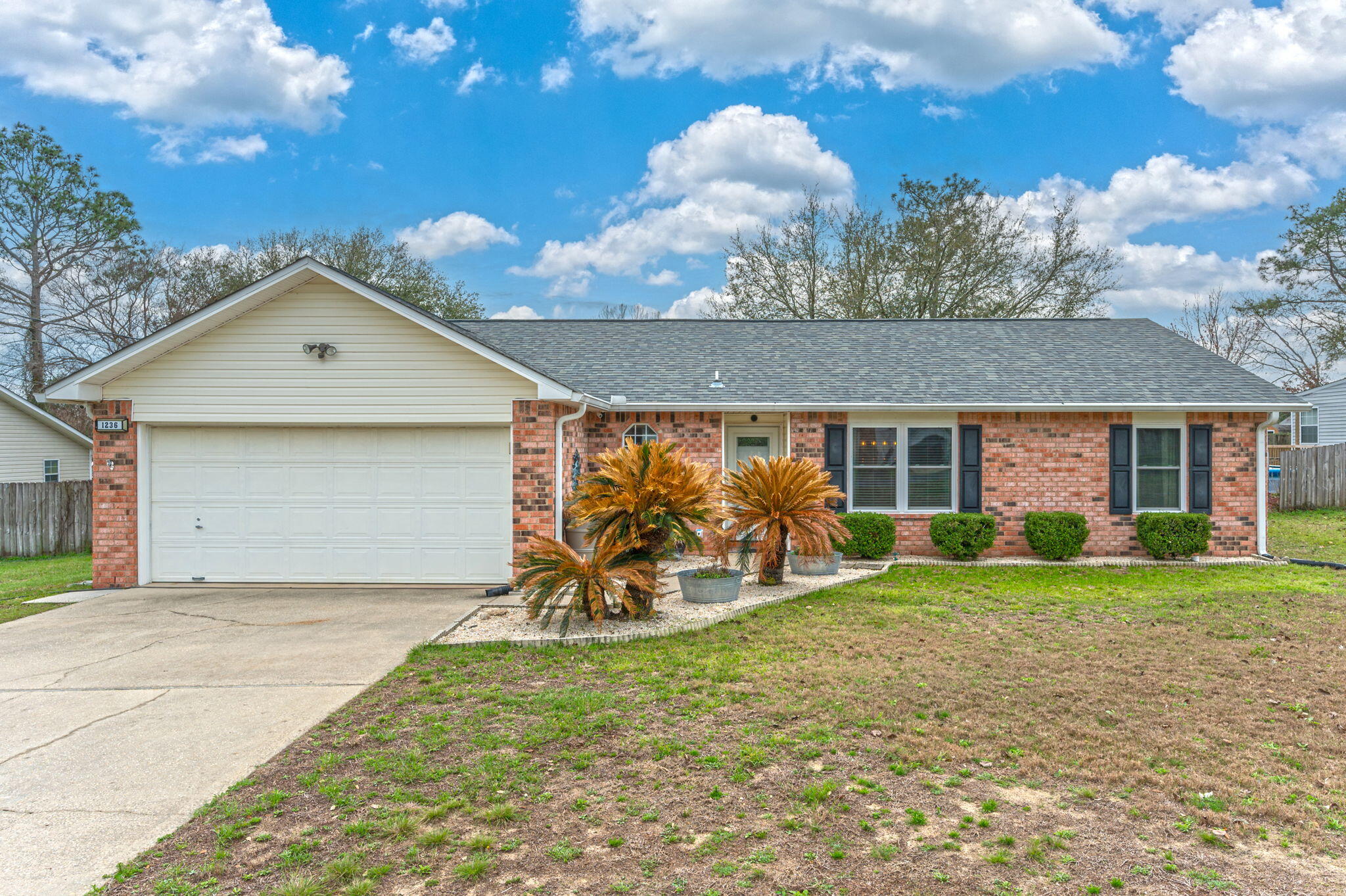 LOCATION, LOCATION, LOCATION... Bases-Schools-Shopping-medical...SO convenient South of I-10, 3 BR makes life simpler! Fresh & Bright split floor plan! Tile in kitchen, eat-in dining area & laundry room. Living area has cathedral ceilings w/French doors leading to screened in Florida room. Primary bedroom offers walk-in closet, Primary bathroom with double vanity and garden tub. Backyard has patio for sunbathing, BBQ's and gardening in the surrounding flower beds. Recent updates include roof, HVAC, Whole-house Gutters, Septic leach field, Water heater, Hurricane windows & Front storm door, all super helpful for Ins purposes. See this one first!