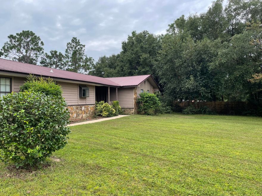 This property is one of a kind!  It has 3 bedrooms 2 full baths on 1.97 fenced acres.  The living room has a large stone wall with wood burning fireplace.  The eat in kitchen is open to an additional living area with a 2nd large stone fireplace.  Enjoy your morning coffee on the screened-in back porch.   The property also features a detached guest house/office that has 100 amp service and window heat. On the back of the property there is an amazing two-story barn that can be used as a garage plus an upstairs loft that offers plenty of storage and a workshop.  This property has many mature pines, azaleas, magnolias and fruit trees. You do not want to miss this one!  Make this your very own peaceful oasis. Buyer to verify all measurements. Sold ''AS IS''.  Prof photos coming soon.