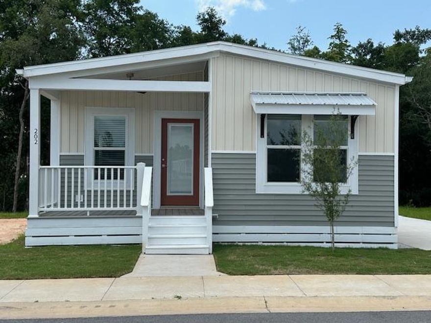 This home is in Riverwalk Landing, a 55+ Retirement Resort. This home redefines modern living with a cozy 957-square-foot space. The thoughtfully designed open layout features 2 bedrooms and 2 bathrooms, seamlessly integrating the living areas for a fluid and inviting atmosphere. The kitchen boasts a   central island, serving asa social hub perfect for gatherings. Washer and dryer are included. The master bathroom offers a private retreat for ultimate relaxation. Enhancing its appeal is a charming front porch, complemented by the serene backdrop of a nature reserve, providing a peaceful setting to unwind and connect with nature. Enjoy the amenities, clubhouse with pool, pickleball courts, community activities and more.