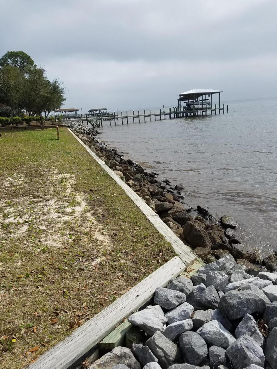 View vivid sunsets blanketing the south and west shores of the bay and sparkling lights from the Mid-Bay Bridge from this large Lake Pippin Bay Front Lot. Upland retention wall and rip-rap protect this beautiful property with lovely trees and excellent elevation. Neighboring homes are large & immaculate executive style residences. Located at the SE end of Lake Pippin Estates for ultimate peace and privacy. Panoramic Views from this property will inspire you.... BRING YOUR IMAGINATION!!!!Buyer to verify all information.