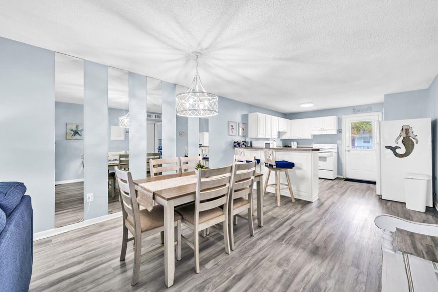 Your beach escape awaits - turnkey, fully renovated in 2022-2023, investment-friendly, and just steps from the sugar-white sands and emerald -green waters of the Gulf.  This updated condo blends coastal charm with modern design, featuring luxury vinyl plank flooring, refreshed bathrooms with new tile and vanity, updated lighting, all-new furniture, new kitchen appliances and new HVAC system.  Step out onto your balcony with pool views or enjoy resort-style amenities including a swimming pool, tennis and basketball courts, picnic and grilling areas, and shuffleboard.  Whether you are looking for a personal getaway, a second home, or an investment property with rental potential, this condo offers low-maintenance ownership in a prime location-move-in ready and waiting for your next adventure The community also underwent a certified engineering overhaul and renovation to meet Florida's inspection and milestone requirements, giving buyers added confidence. Improvements include new insulation in walls for energy efficiency, and fresh paint, sealants and coatings on all exteriors.  Also new hurricane rated windows, new railings, and new brick walkways at the pool.  Exterior work is warranted through C-Sharpe Engineering, and all major improvements are complete.  Seller paid special assessment in full.