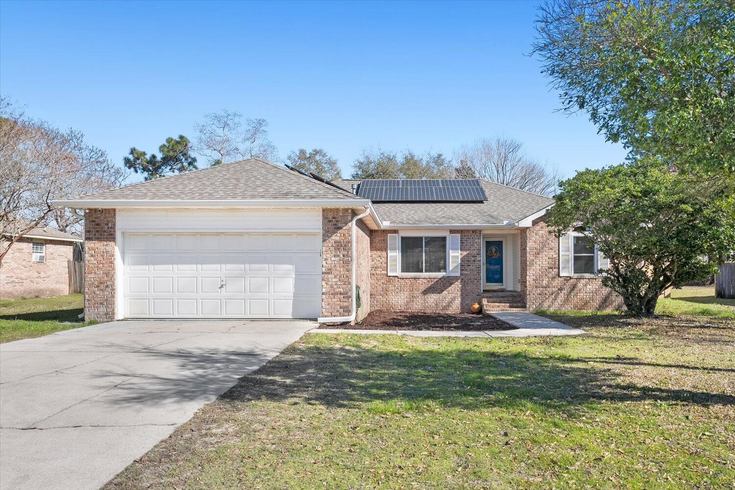 This home features so many new and upgrades that will make living in this home a breeze! New roof in 2020, New HVAC 2023, New Windows Dec 2023. All of the energy efficiency updates have been completed PLUS there are paid off Solar Panels to keep your electric bill to a minimum! Spacious living room with a fireplace and glass doors to the back patio. Updated Kitchen and appliances! Gas Stove! Dining area that could be a second living space/office. Eat in area off the kitchen with windows that catch the morning sun. Generous primary suite. Both bathrooms have been updated. Good sized 2nd & 3rd bedroom. Laundry room. 2 Car Garage. And there is a huge privacy fenced backyard! Within 5 minutes you can be at Navarre Beach, Publix, Starbucks, BWW & Twist ice cream. 11 Miles to Hurlburt Field!