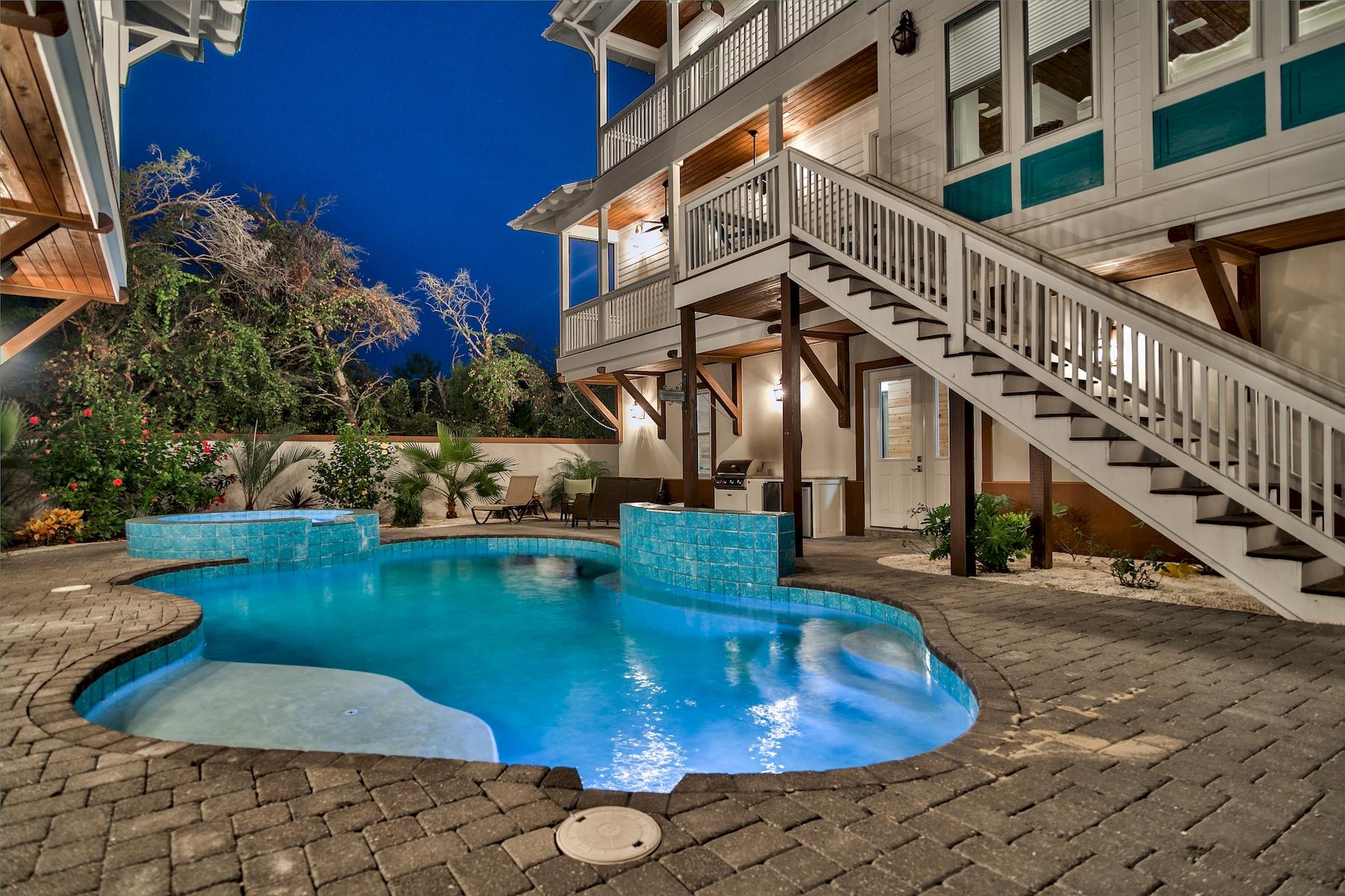 Extraordinary coastal construction primely situated at the south gates of Destiny East with easy beach access boasting an impressive +$168,000 in projected gross annual income. Pristine architectural details define this outstanding six bedroom retreat featuring a full detached carriage house with notable features including a three story vertical footprint, gas lanterns, four car garage, concrete block construction on the first floor and an exemplary private courtyard with lush tropical landscaping anchored by a massive resort style pool.