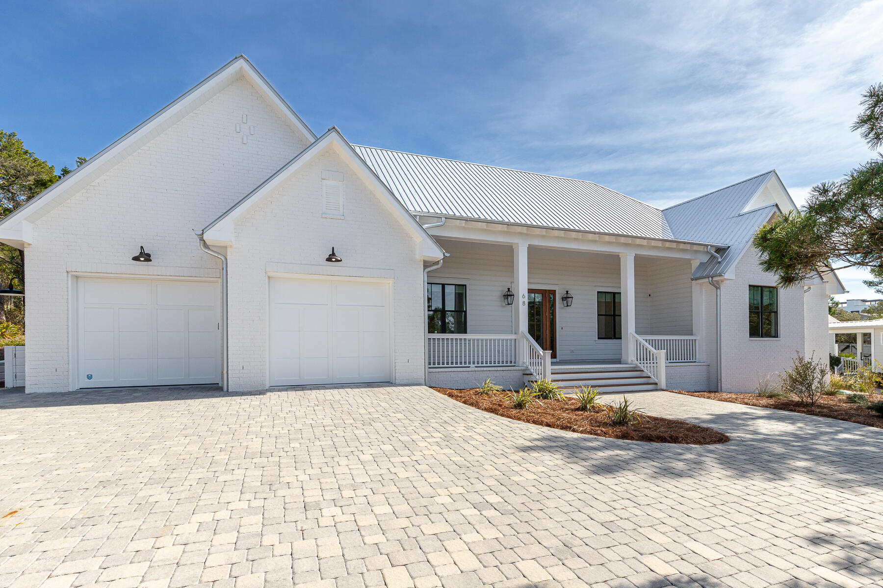 This newer build one story luxury home was designed with privacy in mind set in Blue Mountain Beach on a 1/2 acre lot with 2 car oversized garage. This home features 5 bedrooms and 4.5 bathrooms with additional office/flex space making it ideal for primary residence, second home or rental investment. The upgraded lighting, window shades and furnishings are the epitome of luxury in this private beach oasis. The north wing of the home features a large primary wing with access to patio, large double vanity bathroom, spacious walk in closet to oversized laundry room. This layout opens to pool and patio as well for a true indoor/outdoor living. The open floor plan with a chef's kitchen features high end appliances with butlers pantry, wine fridge, beverage fridge and plenty of storage. The large island on the kitchen leads to dining area with custom lightening above leading into sitting area with fireplace. This room has a flex space that could be an ideal office or bunk room for additional guests. The living space is extended to large screened in porch overlooking pool and spa featuring summer kitchen for ultimate in entertainment. The outdoor pool is an oasis with another fireplace overlooking the peaceful setting with additional storage and an outdoor shower.
On the south wing of the home are 4 bedrooms and 3 full bathrooms. This provides a great space for guests or family members. The home is set back from the road on this large lot offering privacy from each room. 68 Mountain Top Dune Drive is offered furnished as shown with high end furnishings and custom drapery from local Shade and Drape Company in Blue Mountain Beach.
The garage is oversized wit one bay measuring 25 feet in depth to accommodate a 23 foot boat or Tesla Cyber Truck. This location is in the non HOA community of Blue Mountain Beach keeping of cost of ownership low. This residence is surrounded by homes on similar sized lots offering peace and tranquillity just off 30A. There are multiple beach access areas just at the end of the road as well as miles of trails in Point Washington State Forest less than .5 from the home. Relax by the pool after a long day at the beach or hop on your e bikes (new and included in sale) to explore all the surrounding towns along 30A.