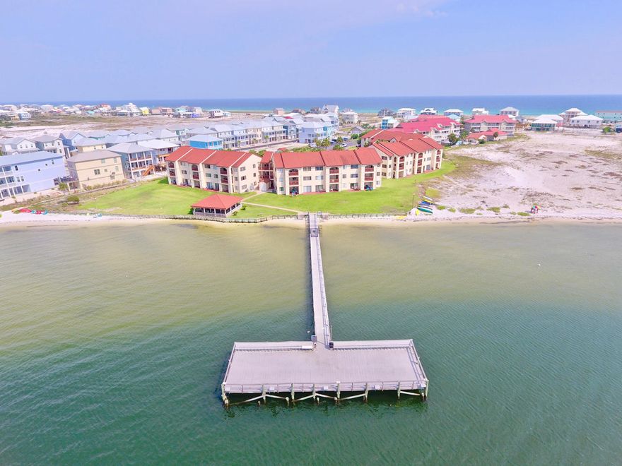 PRICE REDUCED $70K - SOUND FRONT CONDO, AMAZING VIEWS, Gorgeous 2 bed/2 full bath! TOP FLOOR-CORNER UNIT, NEVER RENTED, Completely updated w/top of the line furniture, fixtures, appliances & hardware. Features spectacular views of the Sound from almost every window. Designed by Professional Interior Decorator, no detail was missed! Throughout the entire unit is Crown molding, elegant tiled floors/Travertine in the baths, recessed lighting everywhere, custom wood built-in cabinetry in Kitchen/Master/bath, tiled backsplash in kitchen & baths, granite-topped large island, custom built-in fridge, beachy window treatments, along with like-new Benjamin Moore painted walls. Welcome to Paradise w/ community access to the Sound, fishing/sitting pier, pool and covered gazebo. Click ''More... Watch countless sunsets from your spacious covered private balcony!  Perfect for a primary residence, secondary or vacation rental.  Living area is wired for surround sound.  This building has an elevator for easy access to the top floor. The community is very well maintained with immaculate landscaping and common areas and just a short trip up the road to the Gulf of Mexico or to Gulf Island National Seashore with miles and miles of untouched white sand beaches and Emerald Coast waters.