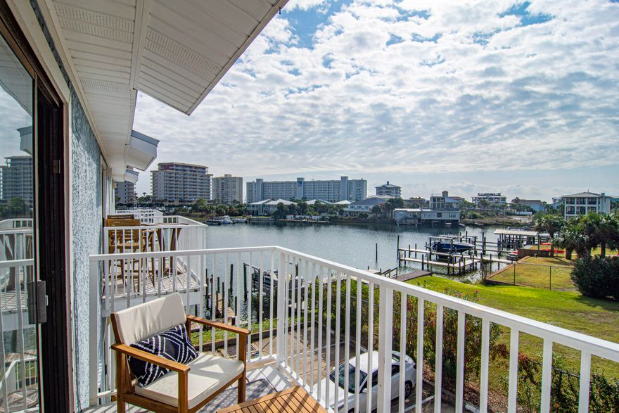 Waterfront condo with on Destin's Harbor lagoon with amazing views. Over 50K in revenue in 2024 and a history of exceeding 60K in short term rental gross revenue. Take the water taxi to Destin's harbor front restaurants and nightlife right from the backdoor, or just grab your paddle boards and enjoy the lagoon.  Just 3 blocks to the white sandy beaches makes this a great location to do it all. 1 card oversized garage with tons of amenities for you or your guests and an extra sitting area.  Deeded parking as well as guest parking available.