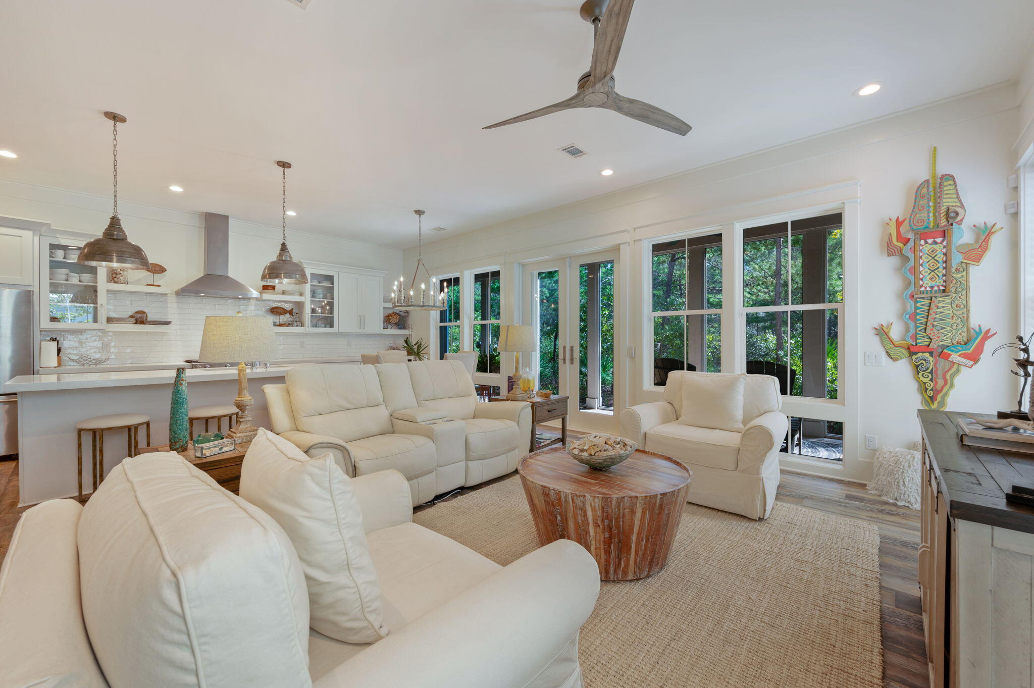Meticulously maintained full-time residence with over 1,000 sq ft of porches& balconies. Owners worked closely with the builder to create a thoughtful floor plan and carefully selected every finish. The living room, kitchen and dining as well as the primary bedroom are positioned on the back of the home for quietness and privacy with a wall of windows to take advantage of the forest views.On the first floor, french doors lead to a 39ft screened-in porch with a beautiful seashell inlay gas fireplace.The kitchen has great flow with plenty of room for cooking & entertaining and features extended white quartz counters and shaker cabinets that span the entire wall, white subway tile backsplash, an island with a large stainless steel sink,(click for