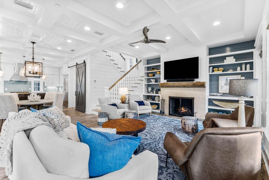 This impressive beach house in Draper Lake Coastal Village enjoys breathtaking gulf views across the treetops from the top-floor balcony. The paver driveway leads up to a two-car garage and the entrance to this six-bed, five-bath home. The screened front porch is one of several outdoor living spaces. Offering a comfortable lifestyle, this spacious home is all about versatility. It's perfect for larger families and those who love to entertain. It boasts a one-bed carriage house with kitchenette and bathroom with its own independent access. The main house has myriad rooms and spaces that could efficiently be utilized as a bunk room, bonus room, second sitting room or home office. The grandeur of the living room immediately captures your attention, with a multitude of windows casting natural light across the generous space. The gourmet kitchen is fully equipped with a large island, quartz countertops, an impressive Thermador gas range, stainless appliances, beautiful lighting, pantry storage and tons of cabinetry beneath a lofty coffered ceiling. Real porcelain ceramic tile flooring and a sliding barn door add a touch of rustic charm. It flows naturally into a family dining area and a sitting room. Coastal decor complements the open fireplace, along with built-in shelving and a wet bar for entertaining. Doors open directly onto the screened porch. A spacious laundry room and a guest bathroom also occupy the first floor. The second floor has three bright bedrooms, with an additional bedroom on the third floor. The spacious master bedroom has its own generous balcony. It's the perfect place to start the day with a cup of coffee while listening to birds in the surrounding trees. The adjoining private bathroom has dual vanities, a walk-in shower, an oval soaking tub in the well-lit space. When it comes to recreational activities, it's hard to beat this coastal dune lake community. Fishing, hiking, kayaking and paddleboarding are on the doorstep and easy access to the beach and Draper Lake make swimming and sunbathing a breeze. Two boat houses, a lookout tower, two community pools and more are part of this gated community lifestyle, with 30A shopping and dining nearby.