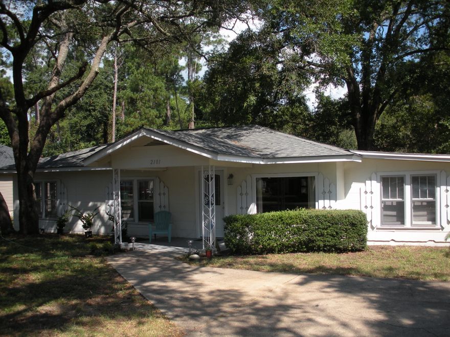 Available Now. Charming 3 bedroom Florida cottage on large lot! The yard is filled with ancient oak trees that create a canopy over the home. This corner lot features a circular drive, so no backing out onto Bayshore drive! Inside you'll find solid pine stained walls and a huge picture window in living room. There are ceiling fans in every bedroom and large closets. This cute cottage also features a bonus room with shelving for additional storage and interior washer/dryer connections. Kitchen has a lot of cabinets and a breakfast bar. Sorry, no pets and no inside smoking.