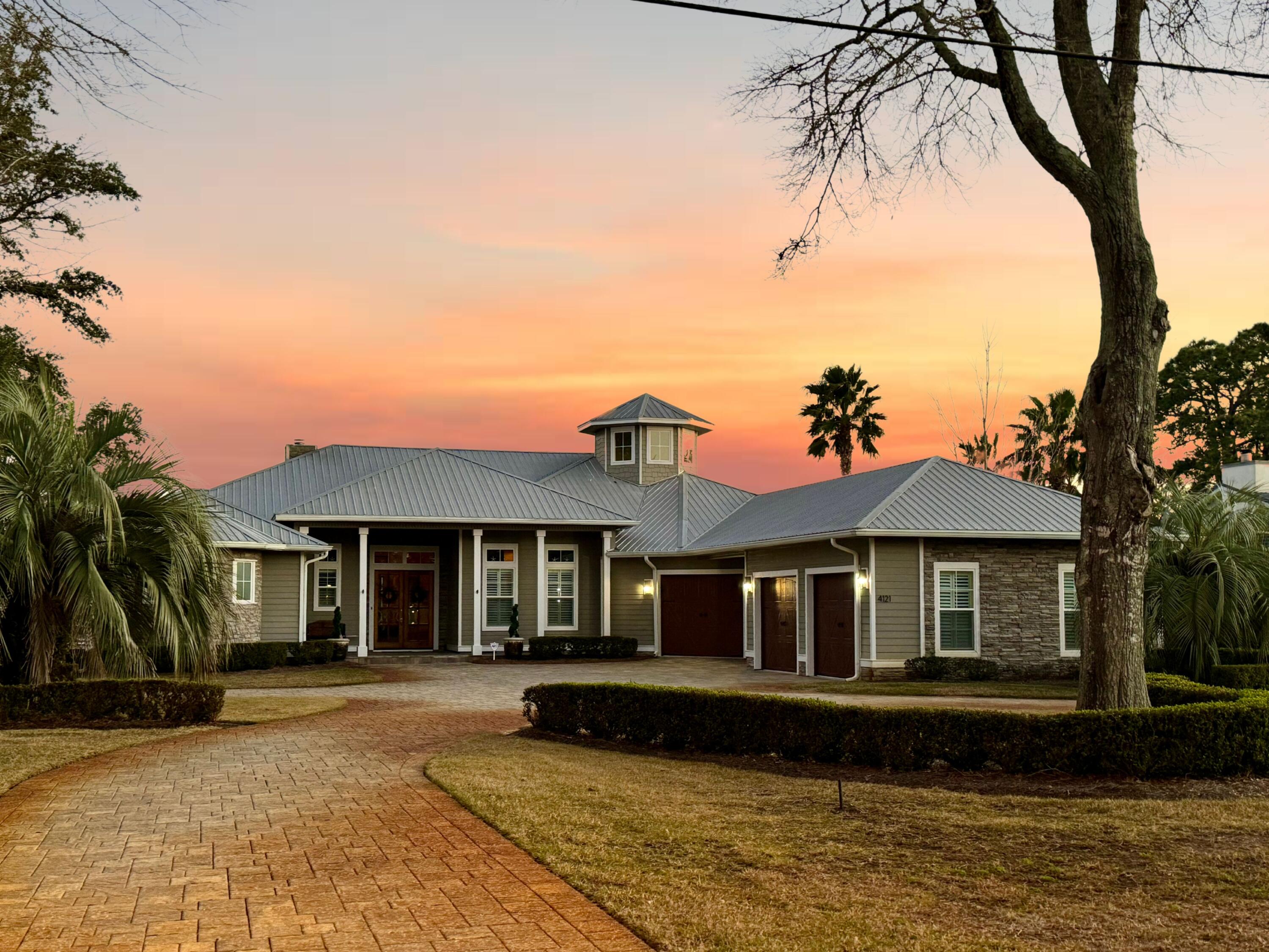 Kick out clause in place. Welcome to your dream waterfront retreat situated on .54 acres with 100 feet of Bayou frontage (Boat included). We are delighted to present this captivating 1-story, 3 car garage home nestled along the water, offering unparalleled views and convenient deep water boat access with power and water on dock with lift for boat and jet ski. New Trex added to dock 2023! The home offers 4 ( the 4th is used as a office currently) bedrooms with 3.5 bath. The outdoor entertaining area is completely screened with gas fire place to enjoy all year long. Stepping out from the lani into tranquility with a backyard that extends to the water's edge. Enjoy peaceful evenings and breathtaking sunsets from your own slice of paradise.Nestled in the heart of Destin