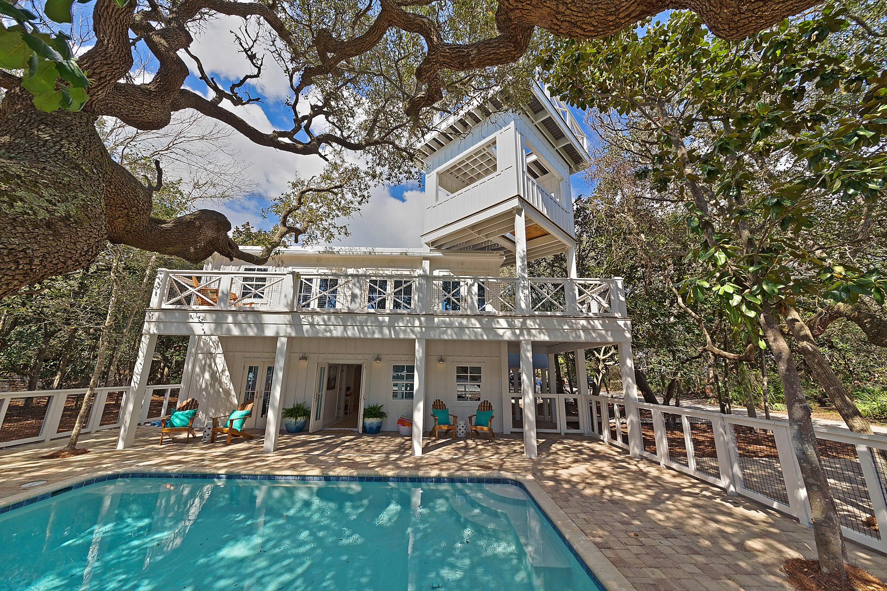 Like NEW! Completely renovated charming Old Seagrove cottage located on 30A just .7 miles from Seaside center. The footprint of this vintage style cottage remains the same, yet with a newly designed floor plan. Enter the property just off the 30A bike path through the fenced gate surrounding the large 12x20 pool canopied by old windswept oaks. Top floor offers an open kitchen (Classic Carrera finishes, Stainless appliances, farm sink, cabinetry w/soft closing drawers) leading to dining and living floor plan with abundant light from the many French doors leading to the spacious south facing porch area overlooking the courtyard pool. Climb the spiral staircase to the tower viewing area; the perfect place to enjoy 30A'a beautiful evening sunsets and the pristine, emerald waters of the gulf. A