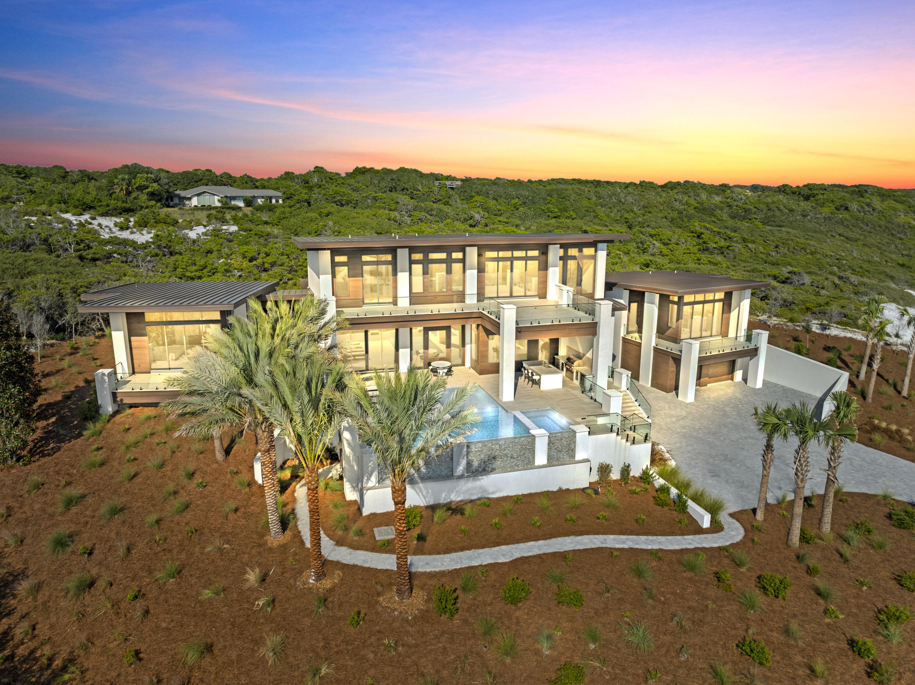Experience the pinnacle of luxury coastal living in this stunning, contemporary home located within the private, gated community of Four Mile Village. The exclusiveness of this neighborhood's private beach is one of its most defining and valuable characteristics. It offers a serene, natural experience where you can walk for miles and often feel like you have the entire shoreline to yourself; a sense of peaceful seclusion that is increasingly rare. Tucked between the sugar white sands of the Gulf of Mexico and the protected natural beauty of Topsail Hill Preserve State Park, this property offers a rare blend of untouched beauty on the Emerald Coast. The sleek, modern design features clean lines and expansive windows that perfectly frame the mesmerizing Gulf views. The thoughtfully designed layout creates a seamless flow between indoor and outdoor living spaces, allowing you to fully embrace the Florida coastal lifestyle. This is more than a home; it's a private retreat in one of the most coveted and exclusive communities on the coast.