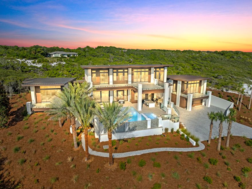 Experience the pinnacle of luxury coastal living in this stunning, contemporary home located within the private, gated community of Four Mile Village. The exclusiveness of this neighborhood's private beach is one of its most defining and valuable characteristics. It offers a serene, natural experience where you can walk for miles and often feel like you have the entire shoreline to yourself; a sense of peaceful seclusion that is increasingly rare. Tucked between the sugar white sands of the Gulf of Mexico and the protected natural beauty of Topsail Hill Preserve State Park, this property offers a rare blend of untouched beauty on the Emerald Coast. The sleek, modern design features clean lines and expansive windows that perfectly frame the mesmerizing Gulf views. The thoughtfully designed layout creates a seamless flow between indoor and outdoor living spaces, allowing you to fully embrace the Florida coastal lifestyle. This is more than a home; it's a private retreat in one of the most coveted and exclusive communities on the coast.