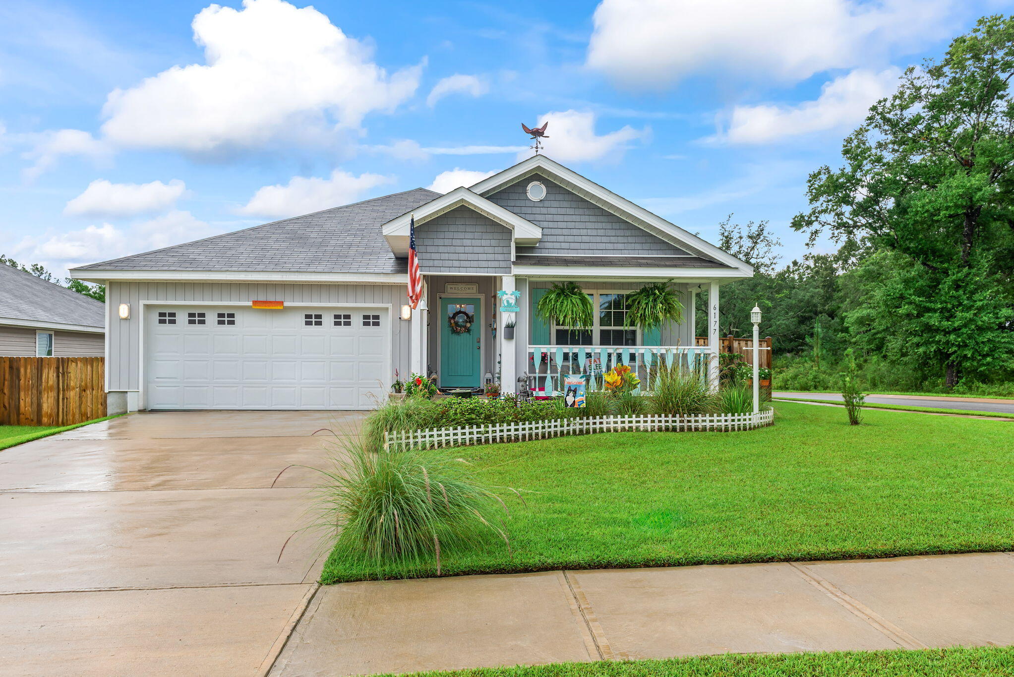You are going to fall in love with this CHARMING beach style cottage and it is just 2 YEARS young! There are so many recent UPGRADES that have been done to make this home truly a ONE-OF-A-KIND custom Florida themed home! There is a WELCOMING entryway into the home and the four bedrooms are arranged in a split plan with the PRIVATE master suite located in the back of the home. The kitchen is OPEN to the living and dining area, with beautiful ENHANCEMENTS throughout INCL: light fixtures, ceiling FANS, a GLASS pantry door, mosaic TILE backsplash, QUARTZ countertops, DEEP stainless steel kitchen sink, brushed nickel kitchen faucet, cabinet door HARDWARE and NEW interior doors. The bathrooms have also been UPGRADED with new light fixtures, quartz countertops, and cabinet hardware! Exterior enhancements include a covered front porch with a wood custom railing, wood custom shutters, front entry door, cedar shaker style vinyl siding, a screened-in back patio, exterior light fixtures, double-sided shadow box privacy fence, weathervane and landscaping. The kitchen appliances, washer, dryer, camera security system, termite warranty, and upgrades are included for the new owners to enjoy!