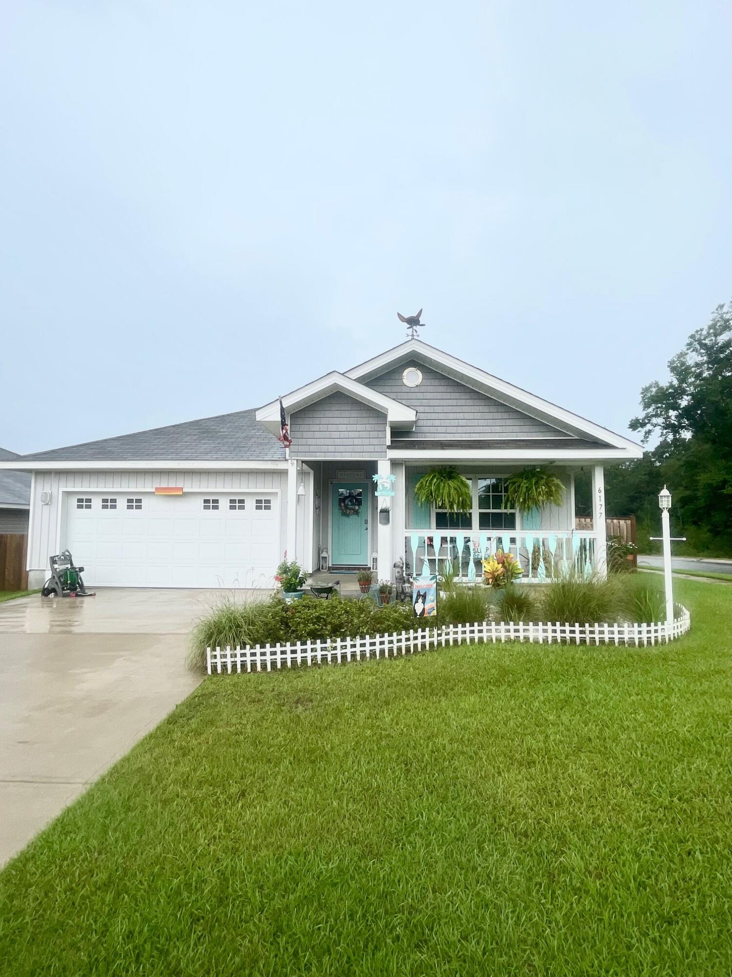 You are going to fall in love with this charming beach style cottage and it is just two years young! There are so many recent upgrades that have been done to make this home truly a one-of-a-kind custom Florida themed home! There is a welcoming entryway into the home and the four bedrooms are arranged in a split plan with the private master suite located in the back of the home. The kitchen is open to the living and dining area, with beautiful enhancements throughout including: light fixtures, ceiling fans, a glass pantry door, tile backsplash, quartz countertops, deep stainless steel kitchen sink, kitchen faucet and cabinet door hardware. The bathrooms have also been upgraded with new light fixtures, quartz countertops, and cabinet hardware. Exterior enhancements include a covered front porch with a wood custom railing, wood custom shutters, front entry door, cedar shaker style vinyl siding, a screened-in back patio, exterior light fixtures, and a double-sided shadow box privacy fence. The kitchen appliances, washer, dryer, camera security system, termite warranty, and upgrades are included for the new owners to enjoy!