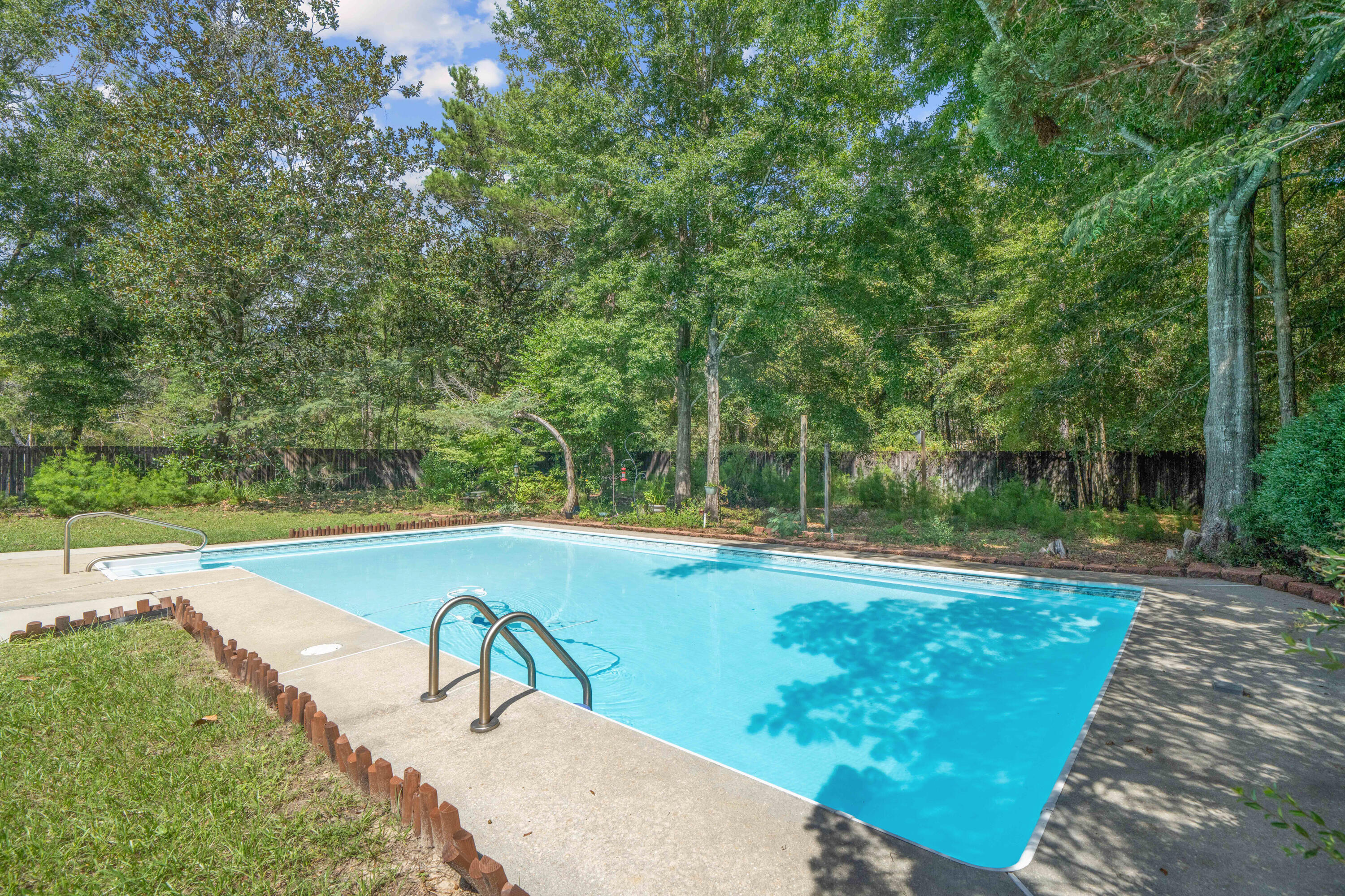 Welcome to this exceptional pool home, nestled on over half an acre in a peaceful cul-de-sac within the highly sought-after Rocky Bayou Estates! Built in 1977, this charming ranch-style home welcomes you with a private entry that leads through two elegant Spanish-inspired arches into a spacious great room, complete with a gas brick fireplace and a separate wet bar--perfect for cozy evenings and entertaining guests. The formal dining room with classic French entry doors offers versatile use as either a traditional dining space or easily converted into a home office or study with bay windows. The kitchen features granite countertops, breakfast bar, cozy kitchen nook, atrium window for abundant natural light and stainless steel appliances--ideal for both meal prep and casual gatherings.