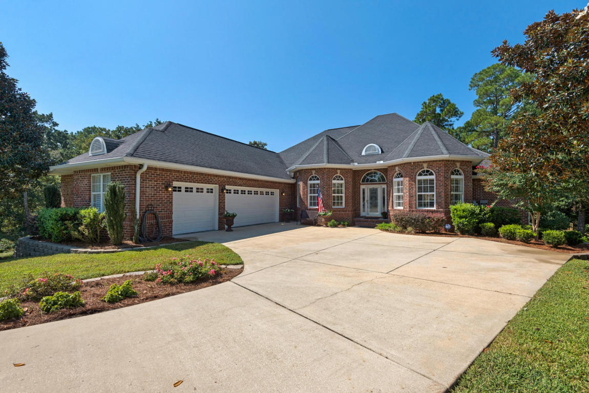Located in the highly desirable Swift Creek neighborhood, this gorgeous executive home features resort style living in the heart of Niceville! Upstairs includes formal dining room with a cedar ceiling, french doored home office, great room with cedar coffered ceilings & gas fireplace, chefs kitchen with a center island and gas cooktop, 3 bedrooms (including master), a full bath, half bath, laundry room and access to the dream backyard! The lower level basement features a 4th bedroom, full bathroom, a second living space with feature brick wall and doors leading outside, a kitchenette, laundry room and giant storage room. Outside boasts an upper deck with outdoor tv, a lower paver deck with an outdoor kitchen and a beautiful pool! The entire outdoor space is screened - 2 stories tall!