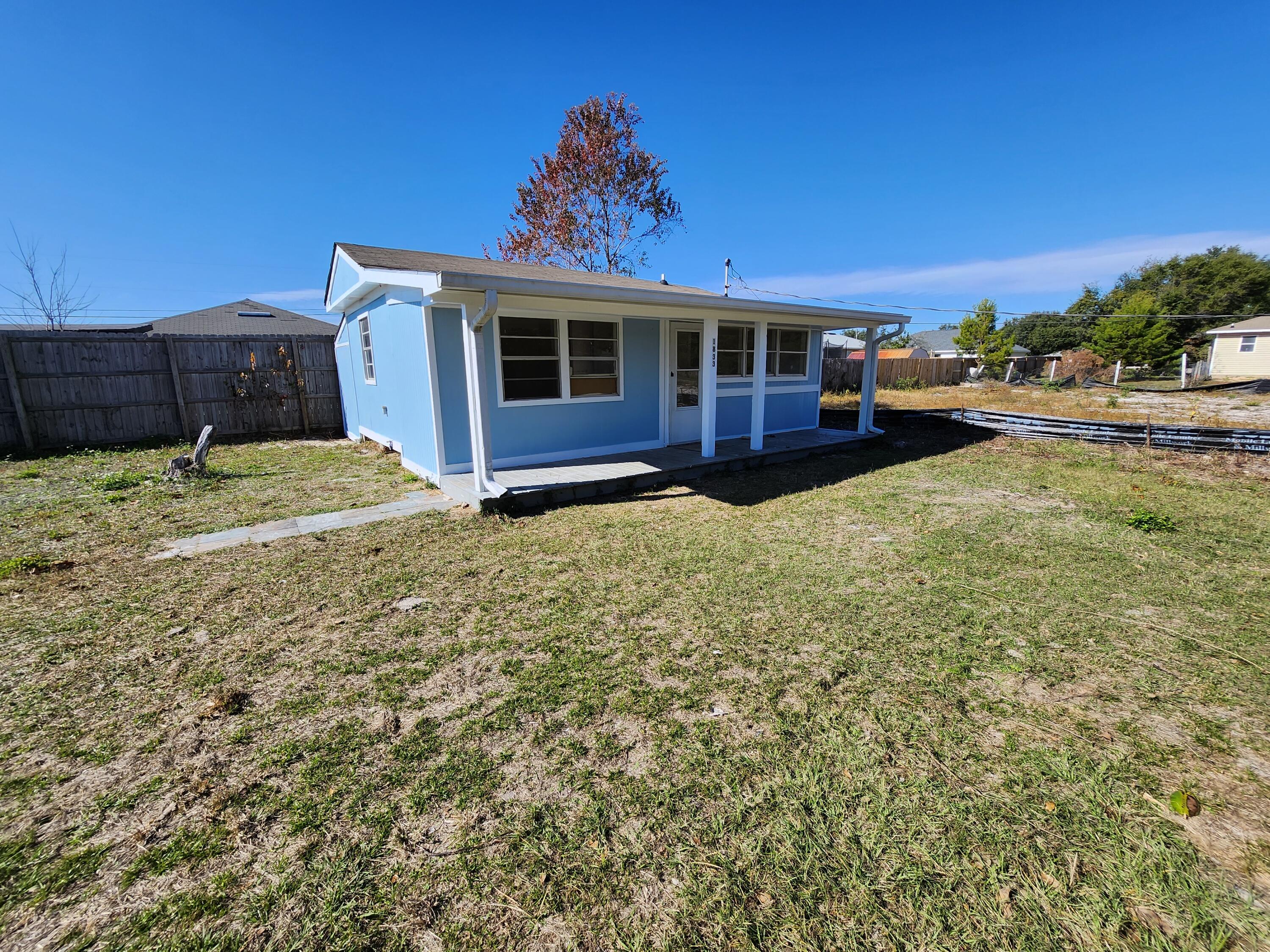 This charming 1 bedroom cottage would make a great investment property or a home base for an avid RV traveler. It would also be the perfect place to store your boat and RV with no HOA restrictions. Recent updates you will enjoy include kitchen backsplash and countertops, new mini-split air conditioning, new tub and floor-to-ceiling tile surround, and a fresh coat of paint inside and out! The entire lot is fenced and it offers a large laundry room with a spacious living area and a bonus room on the back side of the house that would make a great additional bedroom, home office or storage room. It is located 9 miles to beautiful Navarre Beach and also in the Santa Rosa County School District. Check out our full video tour on the MLS and YouTube.
