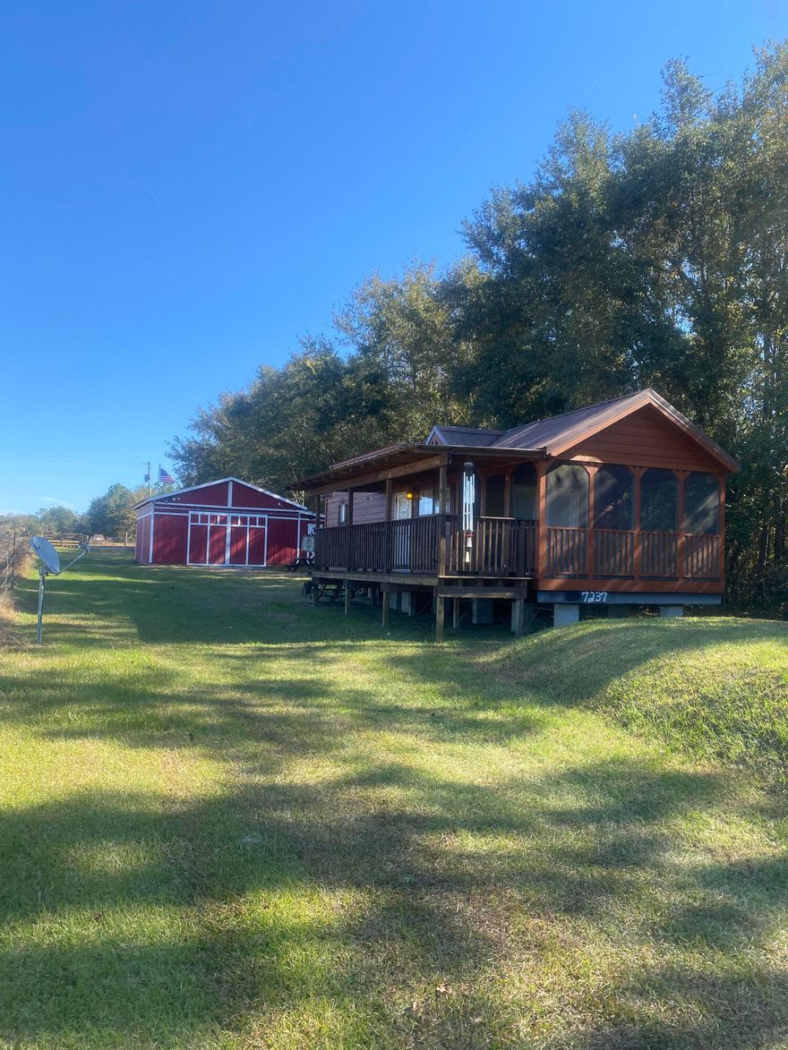 Seller has added an additional 20 acres for a total of 102 acres! There are two parcel numbers, 32-6N-19-22000-007-0010 and 	32-6N-19-22000-007-0020.
This is the getaway you've been waiting for! 82 acres in North Walton County with a tiny home, also referred to as a Cabin on Wheels, and barn. The cabin is built by Stone Canyon Homes in Brilliant, AL. It is the Echoe Model. Find more information at stonecanyonhomes.com.  The barn has several separate storage areas, bathroom and bar area. Well, power and septic already in place. 
The majority of the property is mature hard woods with several trails cleared throughout for hunting, as well as beautiful home sites, if building was your goal.
 This is a must see to appreciate!
Floor plan of cabin in Documents