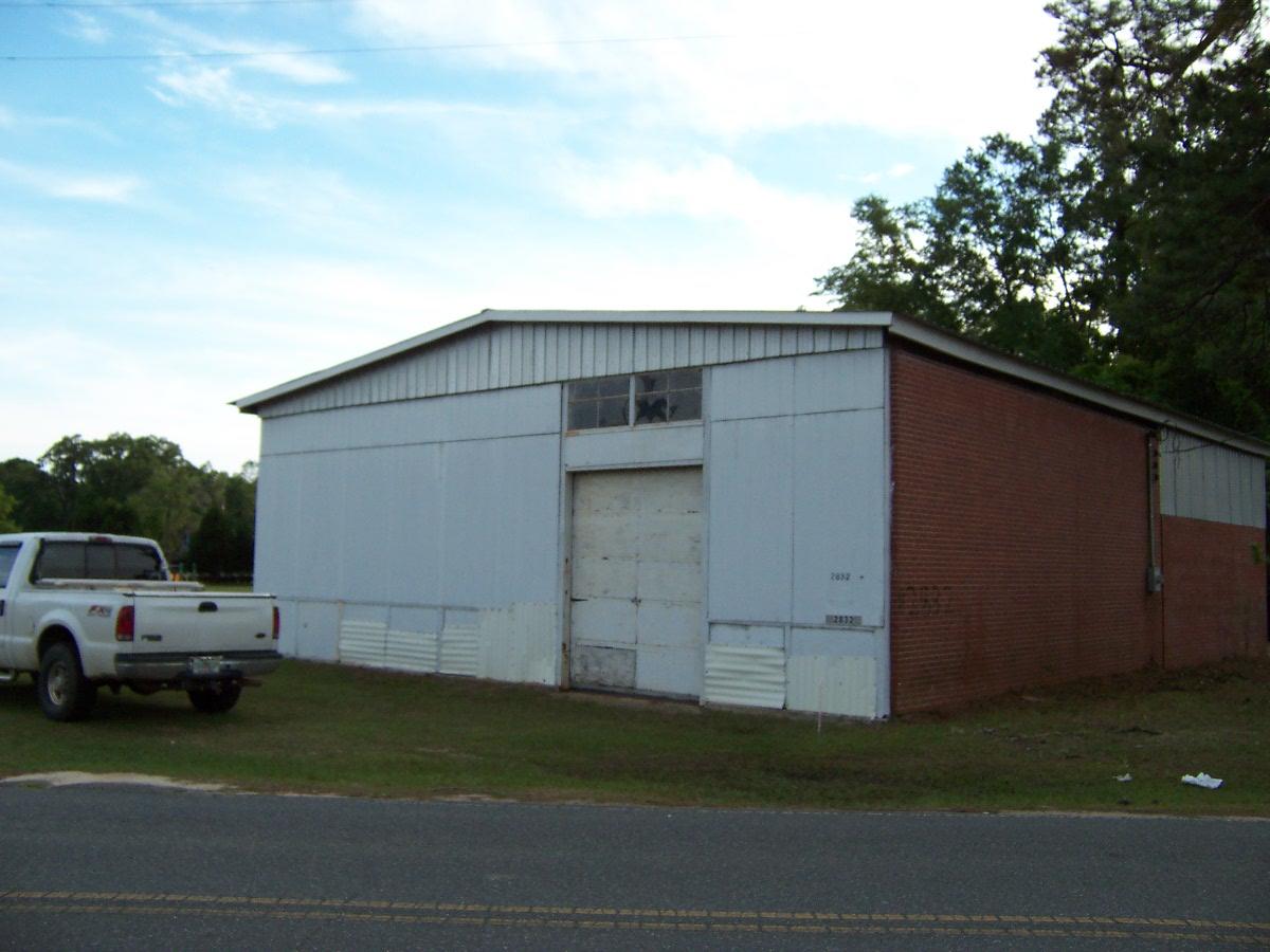 3 Acres on the Corner of 181A (about 550 ft) and US Hwy 90 (about 250 ft) in Ponce de Leon. Per City Hall it is zoned Commercial, but could possibly be changed to accommodate the buyers needs. Property features 2 buildings, the fist is approximately 3,000 sqft brick building with 2 bay doors and very high ceilings, an updated metal roof and electricity to the building. The other building fronts Hwy 90 and is in poor condition. The entire rear of property runs along Blue Creek about 350 ft