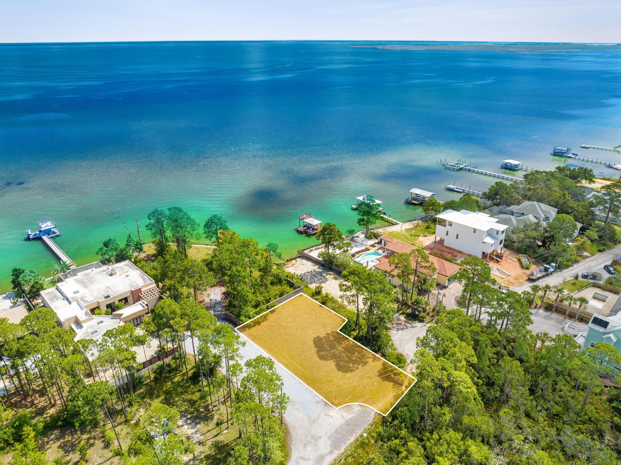 Spectacular Waterview lot offering amazing views of Choctawhatchee Bay located in the heart of Santa Rosa Beach. Property is cleared, dirt filled and ready for building your Florida dream home!! Lot is large enough for sizeable Single-Family Residence and Carriage House. The east side of this lot is bordered by a small state land easement and HOA common area offering unobstructed views of the Choctawhatchee Bay. The owners have provided an existing boundary survey, Dept of Army Jurisdiction letter stating there are no wetlands or vegetation that fall under their Jurisdiction, conceptual site plan design along with proposed plan for a home that would fit on this property. The Conceptual site design even shows there is enough space to build a carriage home, if desired. No HOA Property has deed restrictions. Public water/sewer/electricity are available. Taps have not been paid.
Not only does this lot offer a piece of Paradise for everyday enjoyment with awesome views of the bay, it is only minutes away from numerous world famous sandy white beaches of Florida Emerald Gulf Coast and Destin's Crab Island. Close proximity to 30A beaches, Seaside and Topsail Hill Preserve State Park, Henderson Beach State park and many more beautiful natural resources.
Grand Boulevard, Sandestin Golf & Beach Resort, Silver Sands Outlet, Destin Commons, Destin Harbor Boardwalk offer a variety of restaurants, shops and activities to enjoy. Sacred Heart Hospital and excellence in medical care are minutes away for your convenience.
Buyer responsible to verify all information of importance. Plans provided are for informational purposes only and have not be submitted for county permitting process.