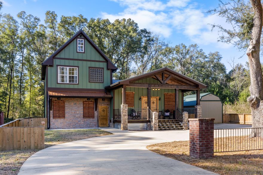 Built in 2022, this stunning custom residence offers five bedrooms and three full bathrooms with no HOA restrictions. A welcoming covered front porch accented by stone columns and exposed wood beams leads to impressive custom-crafted double entry doors. Inside, the home opens to a bright and functional kitchen and dining space featuring granite countertops, a large island, and stainless steel appliances--perfect for everyday living and entertaining.The primary suite is conveniently located on the main level and includes a private ensuite bath accessed through a stylish barn door. The bathroom is well-appointed with dual vanities, a raised jetted soaking tub, a separate tiled shower, and two separate walk-in closets. Nearby, the sunken living room provides a cozy yet expansive gathering  space, highlighted by an electric fireplace with customizable lighting and a built-in heater designed to efficiently warm up to 900 square feet.
A secondary bedroom and full bathroom on the main level offer excellent flexibility for guests or multi-generational living. Upstairs, two additional bedrooms share a full bathroom, while a large loft area provides endless possibilities as a fifth bedroom, home office, or additional lounge space.
Attention to detail is evident throughout the home, from custom trim and baseboards to built-in shelving, detailed stairwork, and an elegant tray ceiling in the kitchen. Durable tile flooring spans the main living areas, complemented by carpet in the upstairs loft. Thoughtfully designed with both privacy and functionality in mind, this home delivers exceptional space and versatility rarely found in one property.