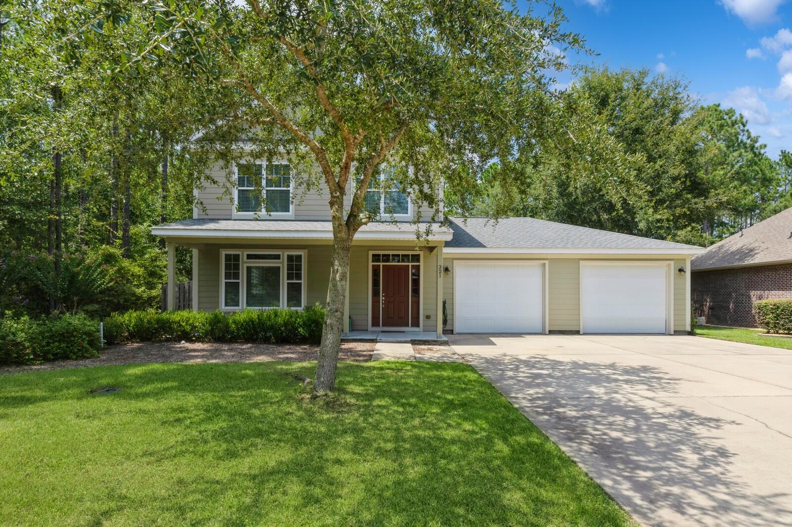 This 3-bedroom, 2.5-bathroom home with a flex space in the Symphony neighborhood of Hammock Bay is a must-see! Symphony is known for its mature trees that shade the sidewalks, and with homes from different builders, the neighborhood stands out for its unique and varied designs. Nestled on a cul-de-sac on Concert Court, this custom built two-story home is just steps away from the Hammock Bay Trail system, offering miles of beautiful, shaded hiking and biking trails. The property spans over 1/3 of an acre, with plenty of room to spread out, and it backs up to a tranquil nature preserve. As you arrive, you'll notice the freshly painted exterior and lush green lawn. The front porch, with its stained wood ceiling and recessed lighting, provides a warm and welcoming entrance.