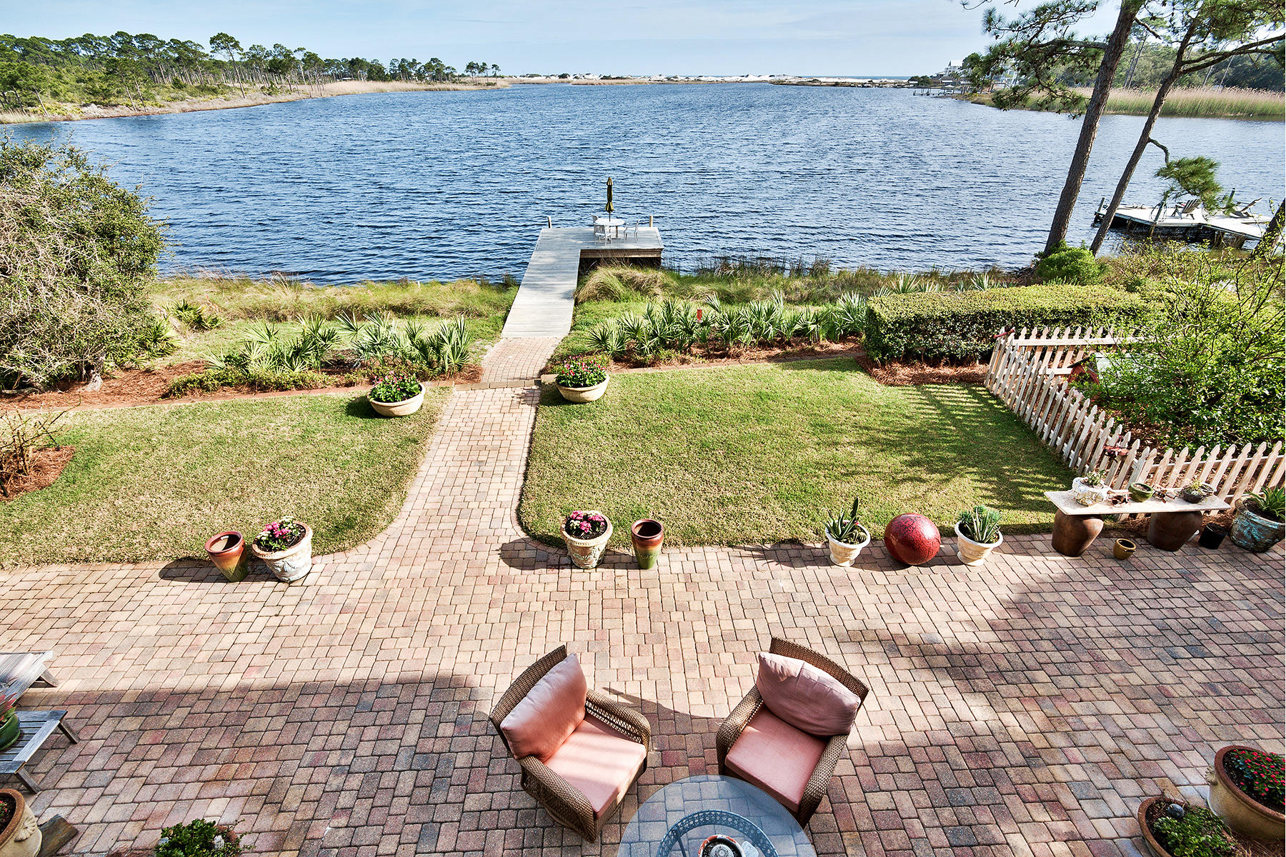 New Price! Custom remodeled in 2008, this retreat is set along the the shoreline of Western Lake in the gated neighborhood of Lakeplace at Grayton Beach. Its unique orientation captures views down the entire length of the rare coastal dune lake towards protected dunes at Grayton Beach State Park. An unobstructed view of the Gulf of Mexico can even be enjoyed from the 2nd floor master suite, office, and guest bedroom, all of which open onto a spacious sun deck. Drop your kayak into the placid waters of South Walton's most explored lake from your private dock, found at the foot of the terraced back yard, and paddle all the way to the beach.