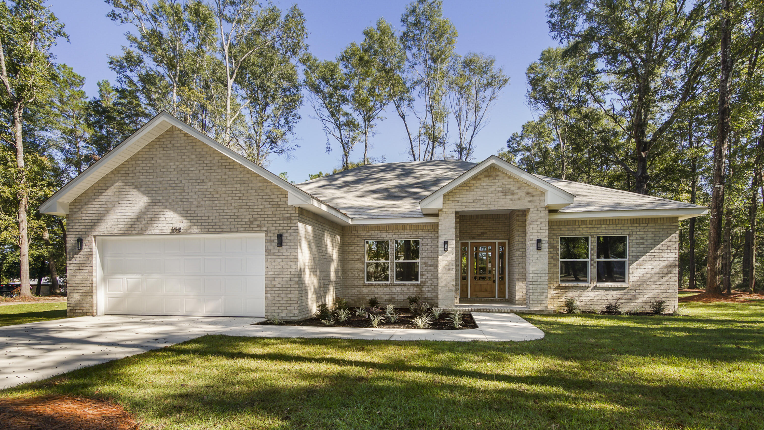 This is NOT your average new build. This brick custom new construction home has many noteworthy high end features not typically found in this size home. Designed with a split floor plan there are 4 beds/2.5 baths, covered porch and 2 car garage, all located on a dead-end street with well established neighborhood and NO HOA. The foyer's barrel vault pine ceiling sets the stage for the exceptional craftsmanship and continues to the tongue and groove cathedral ceiling in the living and kitchen. The all white kitchen keeps it fresh and features quartz counters and the latest high end stainless steel appliances (including a gas range) and a nearly 13' long island, ideal for everyone to gather comfortably. Premium bamboo and tile flooring throughout (no carpet) is ideal for easy maintenance. The vaulted tongue and groove ceilings in the great room stand out, creating a light and open feeling. The master suite features large windows, trey ceiling, 5' tile shower, double vanity, soaking tub and a lovely walk-in closet with custom wood built-ins. The neighborhood is built out with site built homes with no manufactured homes. The home is just outside the city limits near several parks and only 5-7 minutes to downtown DeFuniak Springs. Estimated completion end of October. *Note: all interior photos are of the previous build of this floor plan. There could be changes in design and other finishes.