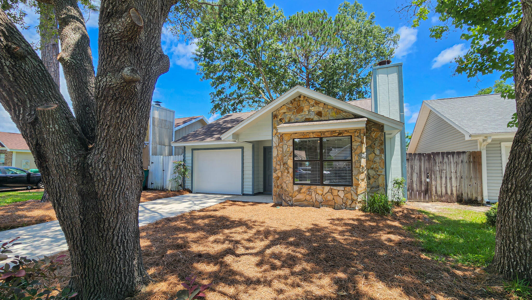 RENOVATED TOP TO BOTTOM! This 3 bedroom single story home is totally upgraded with new flooring, paint, cabinetry, windows & doors, driveway, garage door, etc... also sits on a quiet cul-de-sac! As you walk into the living area, you'll appreciate the open concept layout, cathedral ceilings, stone fireplace, and front picture window. The L-shaped kitchen has new soft close cabinetry, countertops, and appliances. New sliding glass door leads you to the side yard with open patio, all you need to do is bring your grill! Back inside, the 3 bedrooms and 2 full bathrooms are on the rear of the home. The master bedroom has its own access and open patio in the fully fenced yard. Master bathroom and full guest bath have new vanities, sinks, and low-flow shower head, faucets and toilets.