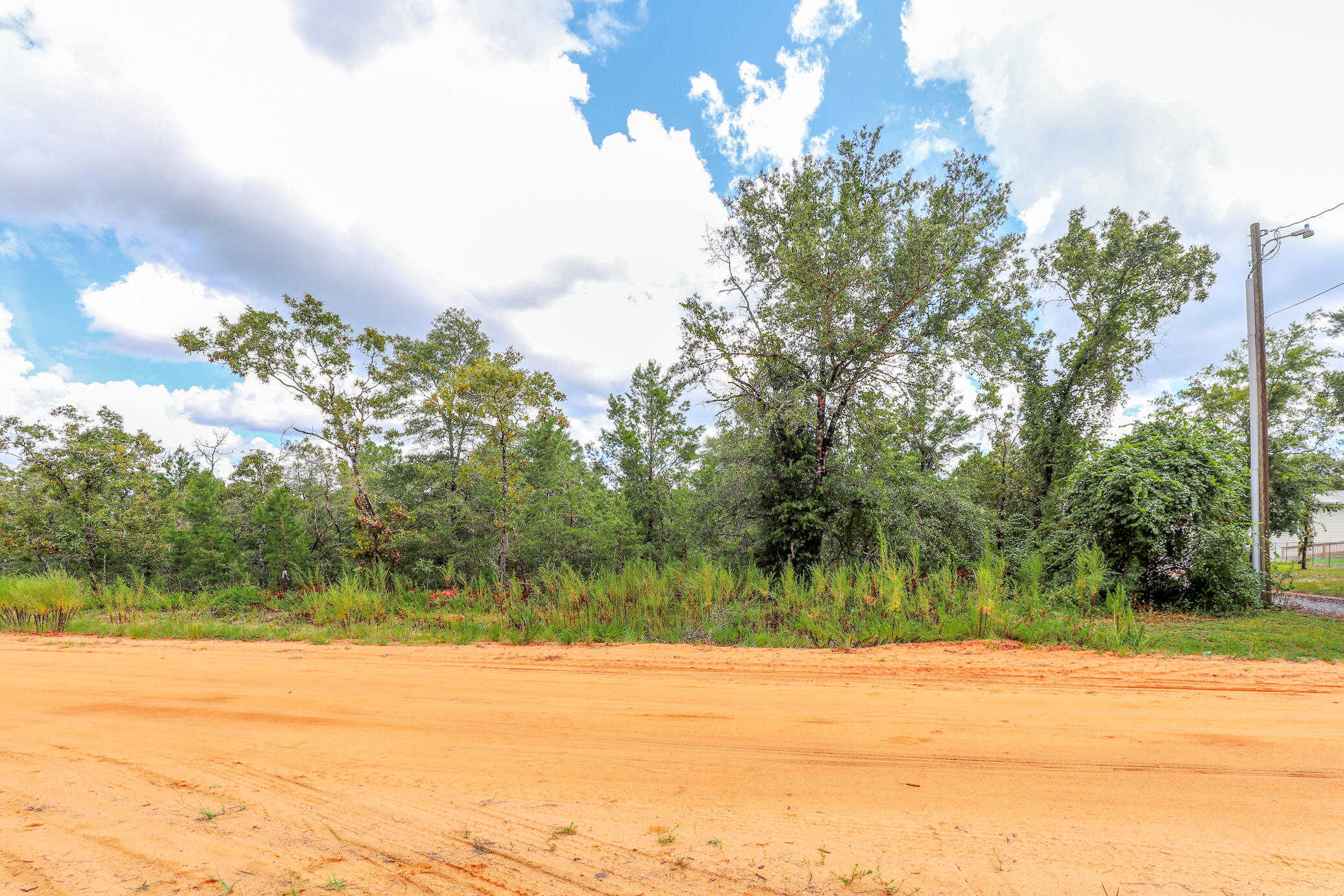 Build your getaway home or place a mobile home. This 0.23 of an Acre wooded lot is located in the Mossy Head area, close to town and has quick and easy access to main highways to take you where you need to go (to have fun or go to work). This property is near many great outdoor activities like fishing, golfing, national parks, and the beautiful beaches of the Emerald Coast! (Close by popular cities: Niceville, Crestview, Destin Florida, 30A / Seaside and Panama City Beach) There are no utilities in place. Power: Available in the area, Water: Public, Sewer: Would be by Septic. Claim your piece of Florida land!