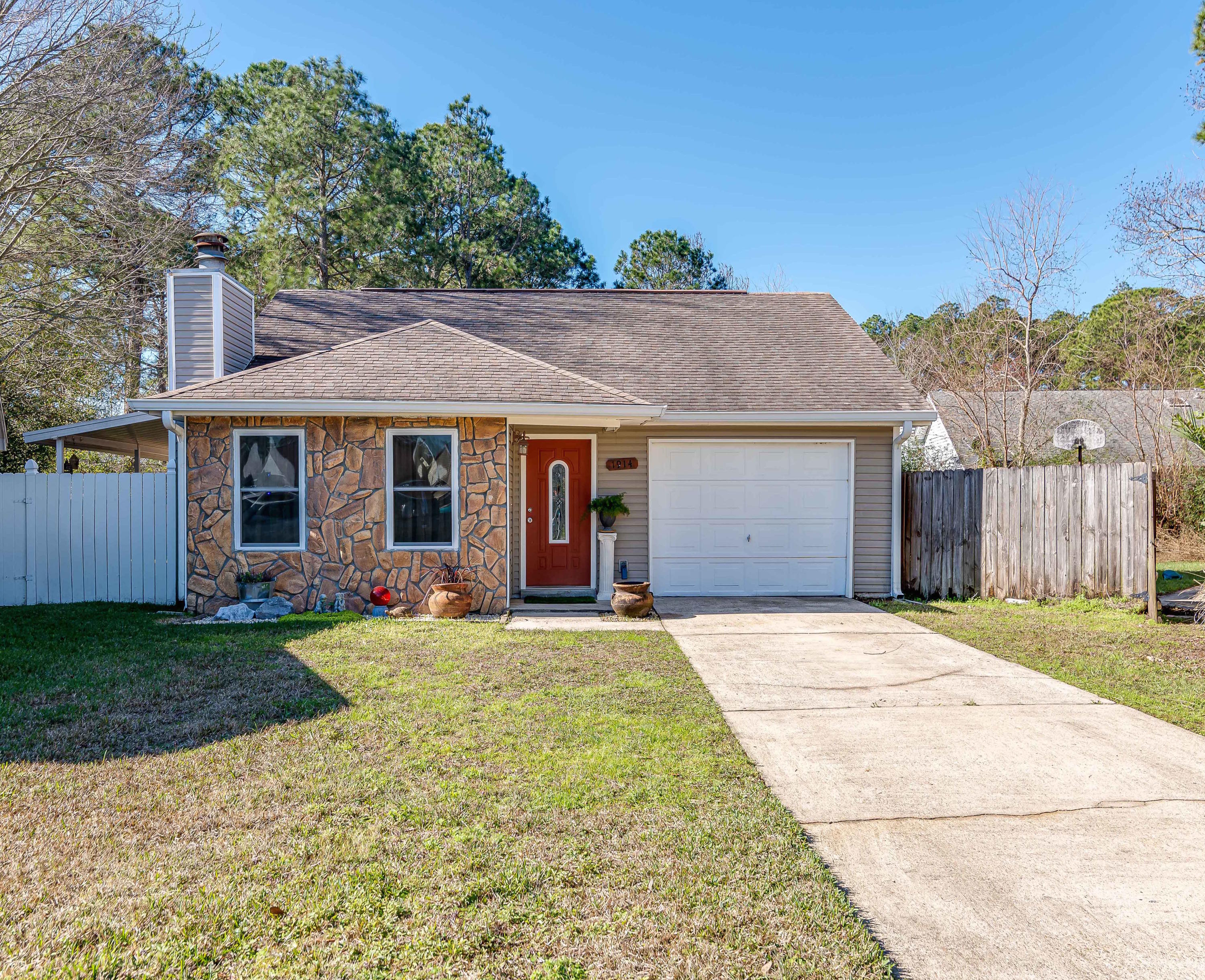 This welcoming 3/2 home on a cul-de-sac is convenient to both bases and lives larger than you would think! This home is immaculate and freshly painted, move-in ready! You walk in to an open living/dining room with vaulted ceilings, wood-burning fireplace, tiled floors, and an adorable freshly painted and bright kitchen. Exit the beautiful french doors in the living room, and enjoy one of the largest backyards on the street, fenced and boasting of a nice covered deck and patio. There is a step-down family/media room just off the living room. The generous Master Suite has its own Sliding door with built-in blinds, exiting to the patio/deck, with double sink vanity, and large closet. The second bedroom, also very large, likewise has the sliding door with built in blinds.