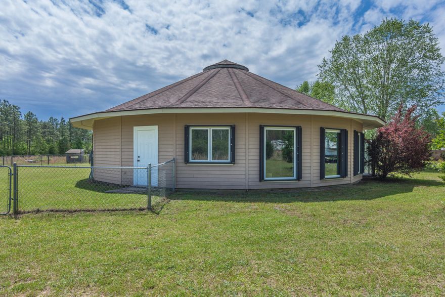 Your country get away is calling you home!!! One of a kind 3 bedroom 2 bath home sitting on 3.5 acres with a pond just east of Milton providing easy commute to all the local bases, beaches, and shopping centers.The build & structure of the home provides ultimate durability & protection during a major storm in addition to a generator bypass & plug in the main panel so you can disconnect from the power line & power the home with a generator. There is a 30/50amp rv hook up panel perfect to store  your rv as well potential for a future work shop. Relax after a long day at work by doing some fishing in your very own pond. Spacious living room with large window overlooking the yard. Wood floors in the main areas and tile located in the kitchen & bathrooms. Kitchen boast ample counter and cabinet space for all your cooking needs. Two of the bathrooms have heated floors.  Some other features to note is hurricane shutters for the entire home, Deltec designed home is hurricane resistant.   See Deltechomes.com. The property is entirely fenced with exception of pond, right across the street from Blackwater Forest, gated entrance, and small storage building. Schedule your showing today!