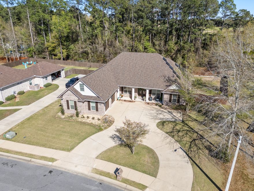 As you enter this thoughtfully designed custom all brick home built in 2014 by Robert Davis, you're welcomed by a dedicated office featuring custom built-ins and a dual workspace, perfect for working from home, followed by a formal dining room ideal for hosting and entertaining. Continuing into the heart of the home, the living room offers a warm and inviting atmosphere with soaring ceilings, custom built-in bookshelves flanking a cozy gas fireplace for added comfort. The kitchen is beautifully appointed with granite countertops, stainless steel appliances, a breakfast bar, and an eat-in dining area that overlooks the pool, creating the perfect space for everyday living and entertaining. Moving through the home, you'll find a well-designed layout that includes a spacious primary suite with two walk-in closets--one featuring a built-in vanity, the bathroom with a seperate tile shower and garden tub for a true relaxing retreat. Additional bedrooms including a private wing with an en-suite bathroom that offers handicap accessibility, making it ideal for multi-generational living or guests. Upstairs, a versatile bonus room with its own HVAC system and private entrance from the garage provides endless possibilities as a teen suite, game room, or guest retreat. Step outside to your private backyard oasis, where a covered saltwater in-ground pool and spa create the perfect setting for relaxing or entertaining year-round. Additional highlights include a 2023 whole-house generator, a large pantry, a separate laundry room with cabinetry and sink, and a 2-car garage with extra storage space and a tiled dog bath. 2025 roof with paid off solar panels! With its thoughtful design, flexible living spaces, and exceptional upgrades, this home is truly a must-see.