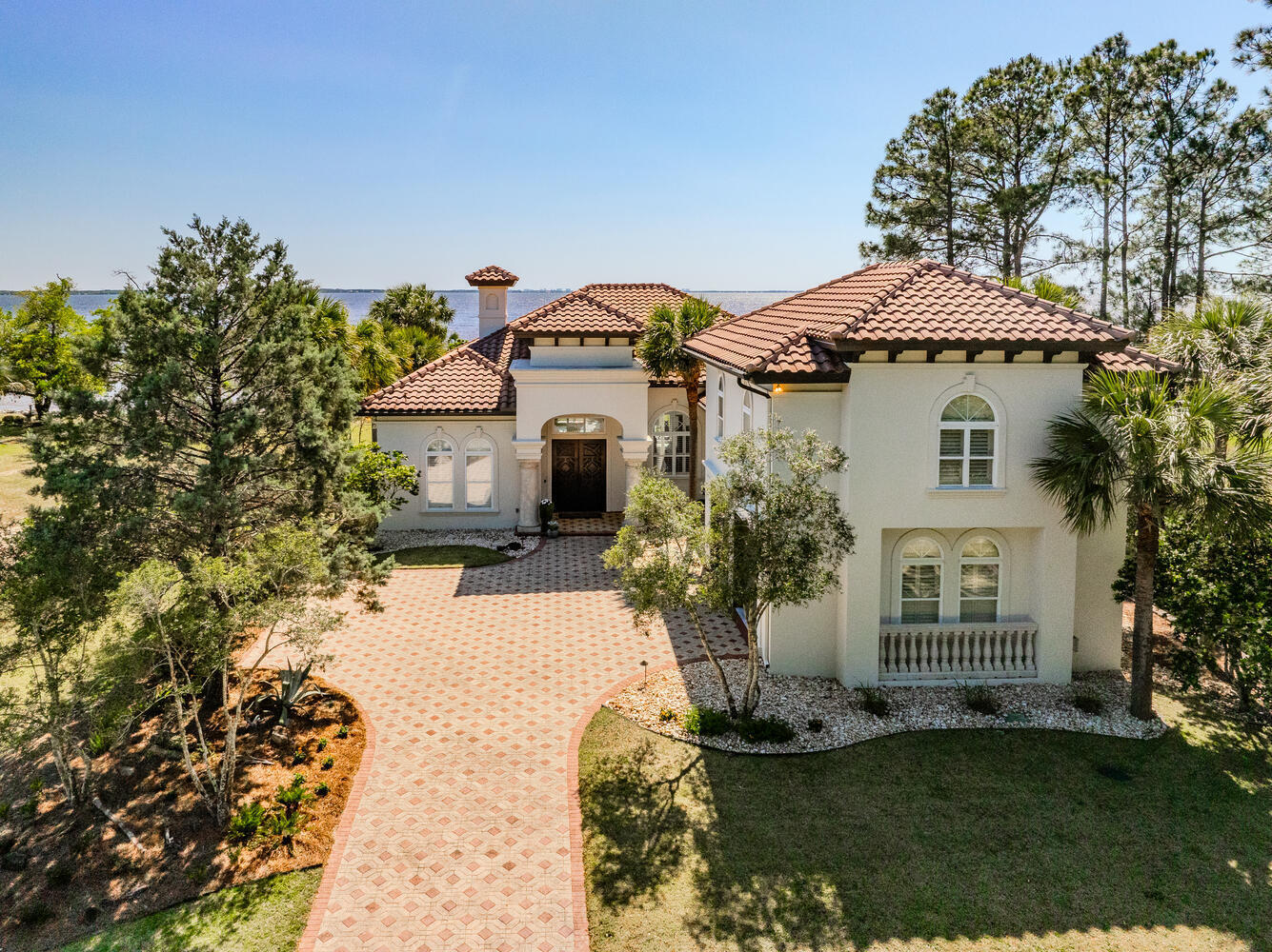 This remarkable bayfront property is truly a one-of-a-kind gem! With a dock featuring a swim platform built in 2021, and a thoughtful conversion for potential boathouse use, this home offers unparalleled waterfront living.A major remodel completed in 2022 has transformed the interior, including a completely new kitchen with all-new cabinets, fixtures, and appliances. Enjoy entertaining with ease thanks to the addition of a wet bar complete with an ice maker and wine cooler. The kitchen boasts three charming arched windows and has been expanded into an enclosed breezeway, creating a delightful sunroom.The living room features three sets of three-panel sliders, flooding the space with natural light and offering seamless indoor-outdoor living.