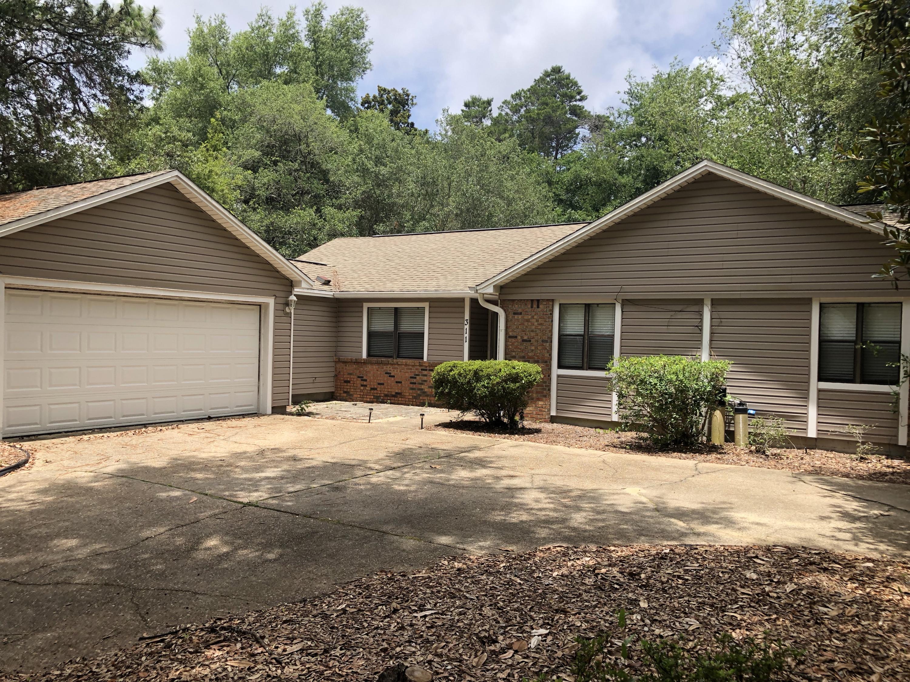 Charming home in Niceville's Bluewater Bay Area. Large Lot with mature trees offer an abundance of shade. Popular ''L-Shaped'' garage configuration. Inside, you'll find a large living room, brick fireplace, vaulted ceiling, eat-in kitchen, formal dining area, large pantry, and oversized master suite. A screened in patio overlooks the large fenced-in backyard. Schedule your showing today!
