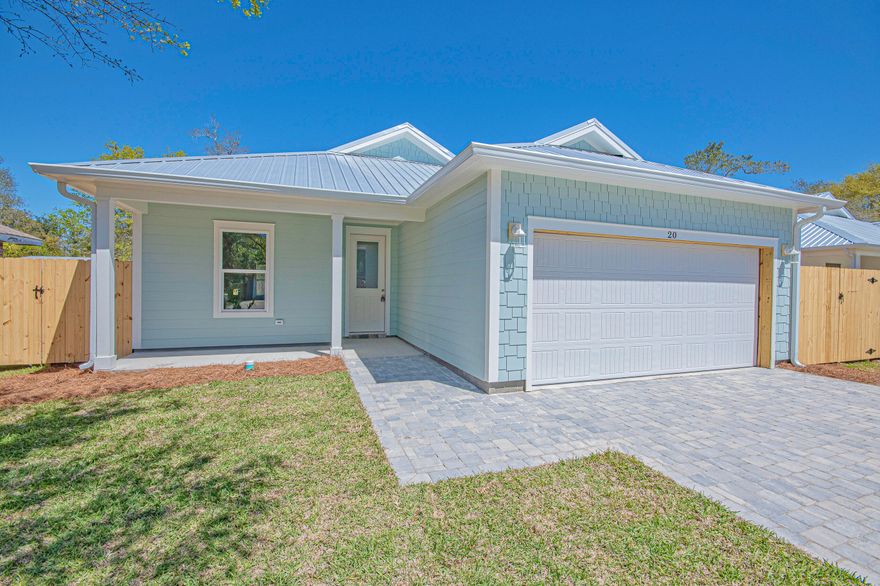 Step into this semi-custom home beautifully designed with plenty of upgrades. Let's start outside. This home greets you with hardi siding, impact windows and doors, metal roof (all for discounted insurance rates), cornered back patio, sodded yard with irrigation, privacy fenced back yard, and paver driveway round out the outside. As for the inside, let's start with the kitchen, white shaker style cabinets with crown molding, built-in microwave in island, a gas stove with stainless steel vent hood (venting to the outside), full-size refrigerator with water & ice in the door, dishwasher, garbage disposal, all under gorgeous quartz countertops. Moving on, all 8 foot doors and  plank vinyl flooring throughout the home as well as 9/10 foot ceilings. Plenty of can lights as well as upgraded