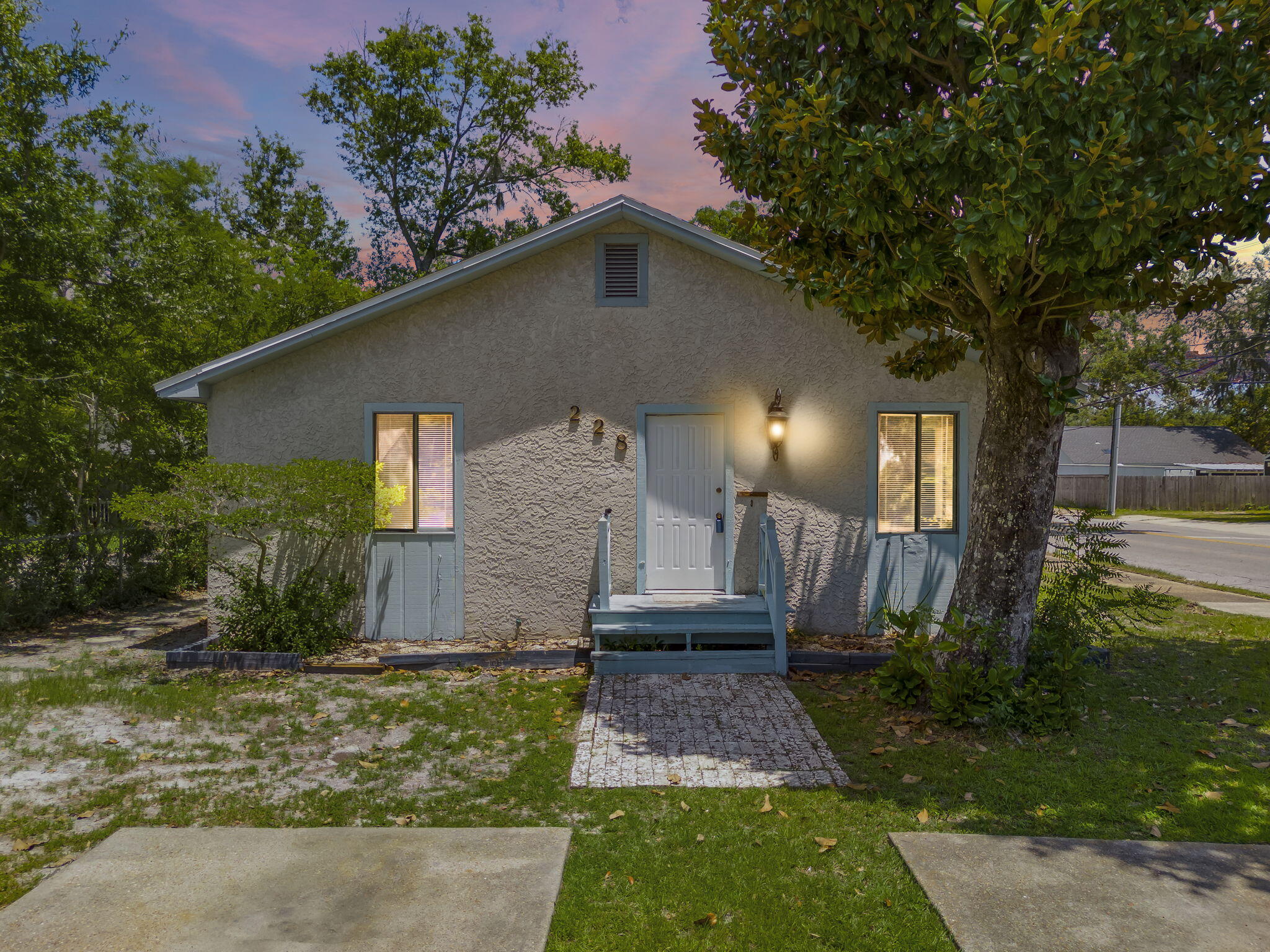 Nestled in the heart of The Cove, just across the street from the beloved Holy Nativity Episcopal School, this charming Florida home invites you to slow down and savor the beauty of historic coastal living. Recently refreshed with full interior paint and brand new flooring, this move-in ready space offers a lovely blank canvas to make your own. The roof was replaced in 2019, adding to the thoughtful updates already completed. The backyard features a chain-link fence with gated access to the alley, offering added convenience for parking, gardening, or simply enjoying the outdoor space. The Cove is one of Panama City's most treasured neighborhoods, known for its golf cart friendly streets, beautiful tree-lined blocks, and rich history dating back to the 1920s. Just a short walk, bike ride, bike ride, or golf cart trip brings you to the waterfront on Beach Drive, where you can take in the most breathtaking sunsets imaginable over St. Andrews Bay. Enjoy being only minutes from Downtown Panama City, where some of the area's most delicious cuisine and local entertainment await. Whether you are drawn to the gentle coastal breeze, the sense of community, or the timeless charm, this home is ready to welcome you. Water Heater - 2021 and HVAC Outside Condenser unit 2020