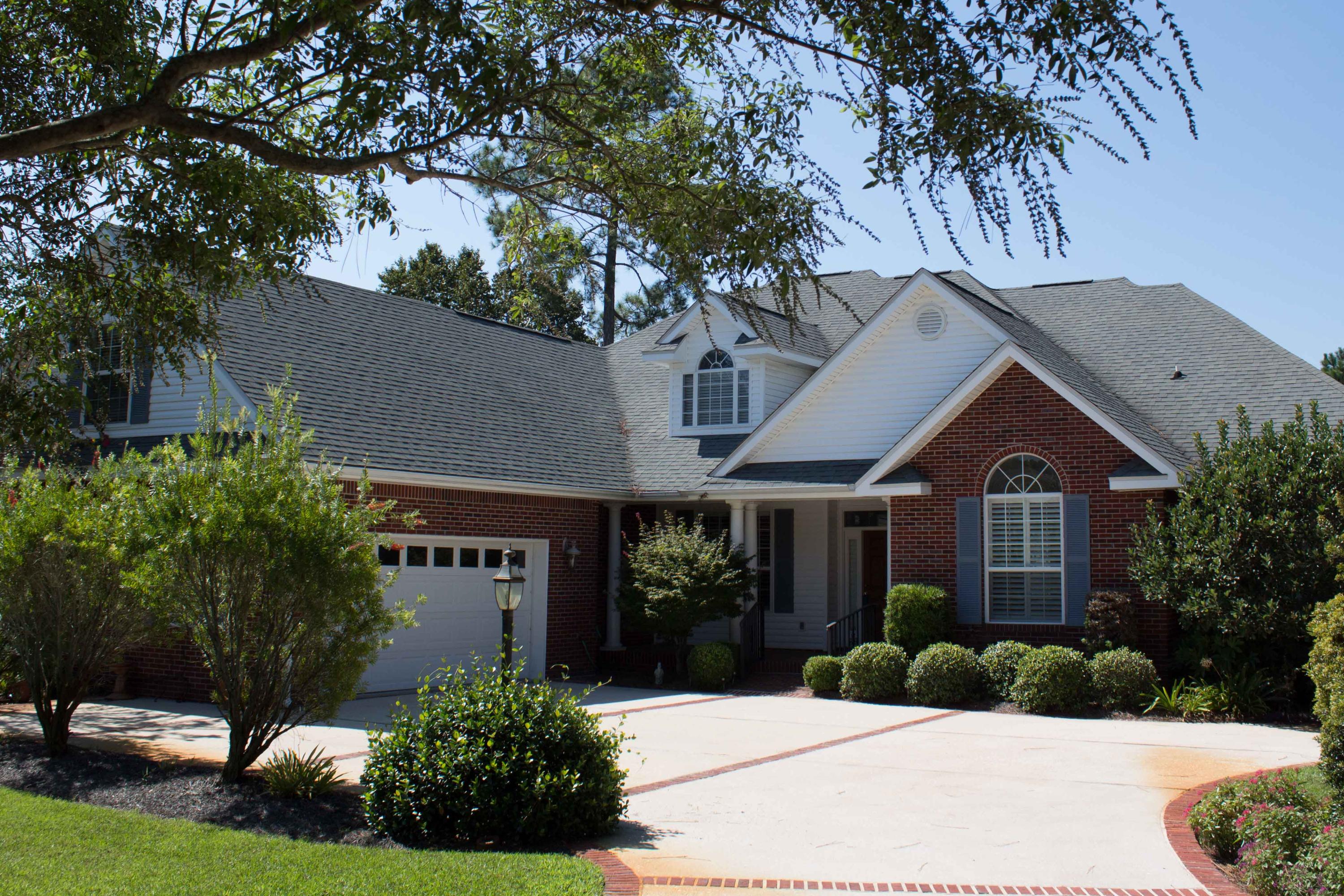 This home is the ultimate in Southern charm and is located in the gated neighborhood of Magnolia Plantation at Bluewater Bay with on site security officers. This location allows you to enjoy peace and quiet while living on a lake in the desired area of Bluewater Bay. The floorplan includes two first floor large master suites along with two other bedrooms all situated in a split bedroom plan. There is an additional space upstairs that would be a spacious office, study or fifth bedroom with a full bath. This floor plan offers plenty of privacy for all. Beautiful wood flooring greets you as you enter this home with a formal dining room, kitchen, breakfast room and sunroom all off the main living room area. The kitchen has new Kenmore stainless appliances and solid surface countertops.