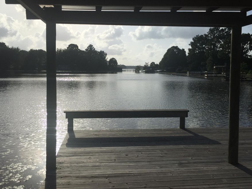 NOT JUST ANOTHER WATERFRONT!LOOK AT THIS--Power pole,septic tank,well,Deep water large lot,18 X 20'covered metal pavillion with paved parking,10'X 20'enclosed utility shed,18x24'new dock with stainless steel nails,38'walkway to dock($15,000.00 value),entrance and exit is paved off of Black Bass and Widner Circle.county states this lot is .97 of an acre.A mobile home was once there and has been removed.Seller states that well and septic were operable at time of removal.Sun sets directy across from this lot,beautiful site to see.Do your due diligence on square footage and lot ammenities.Juniper Lake is also a state maitained lake.